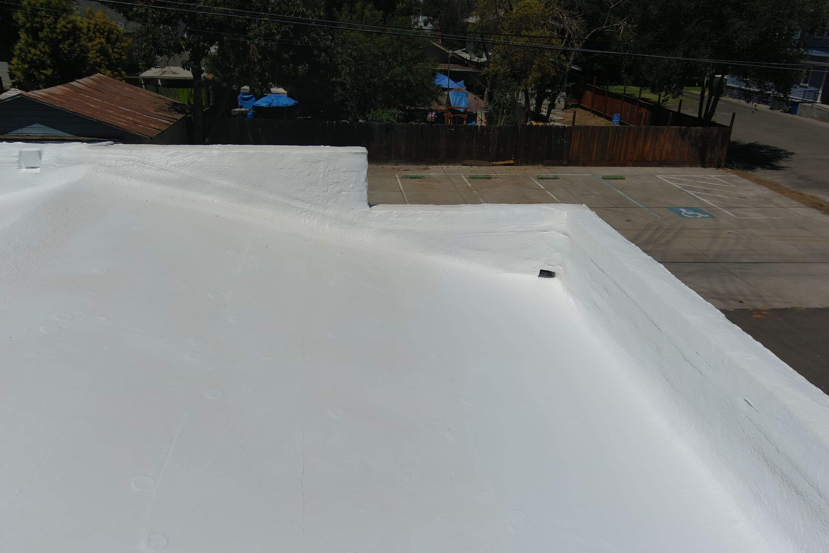 Commercial Roofing Installation using Conklin BenchPly system with PUMA top coat (imbedded fabric system) by Straight Edge Roofing Inc