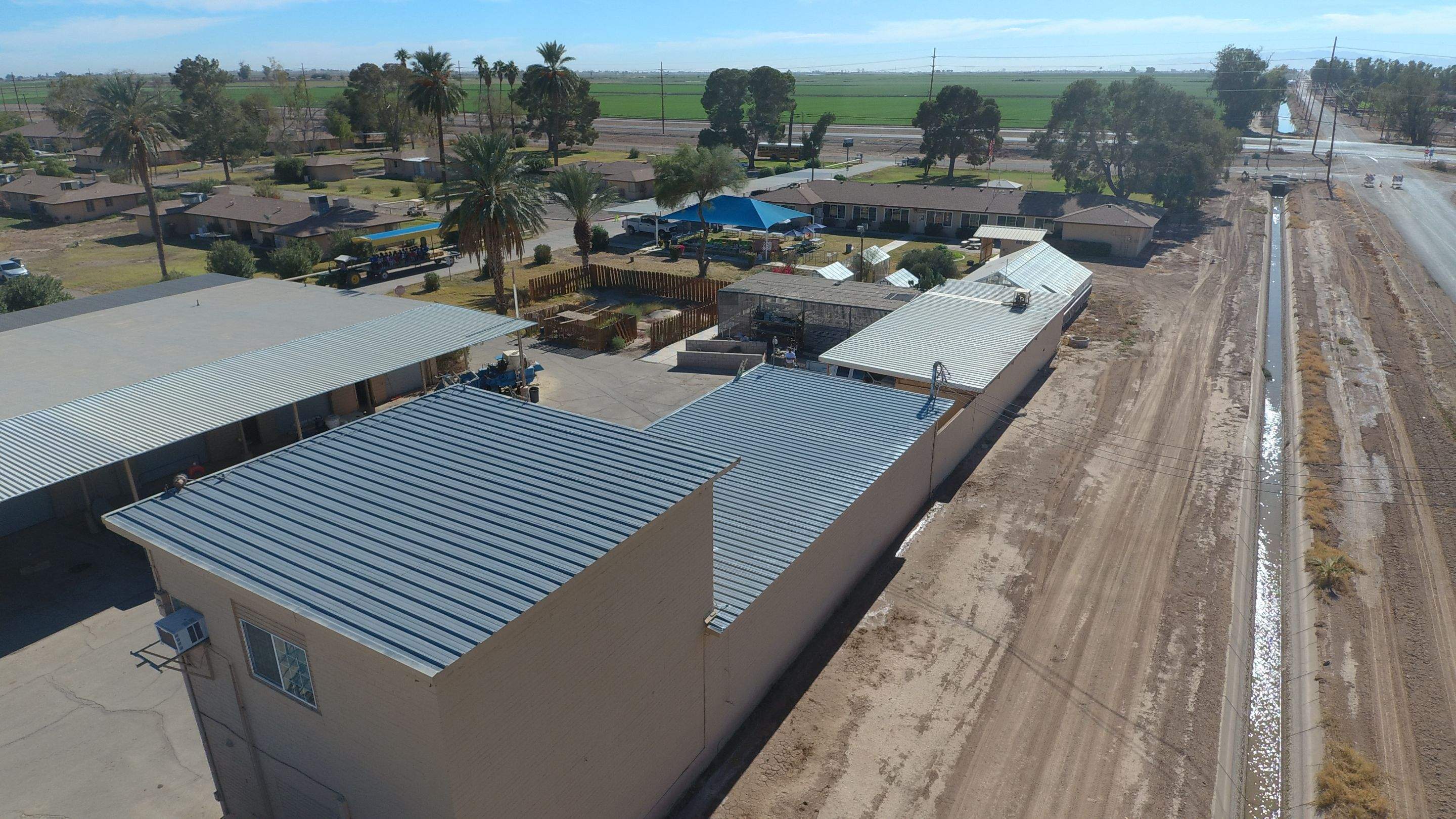 Metal roof restoration on commercial roof using Conklin Benchmark/PUMA XL fabric and coating by Straight Edge Roofing Inc