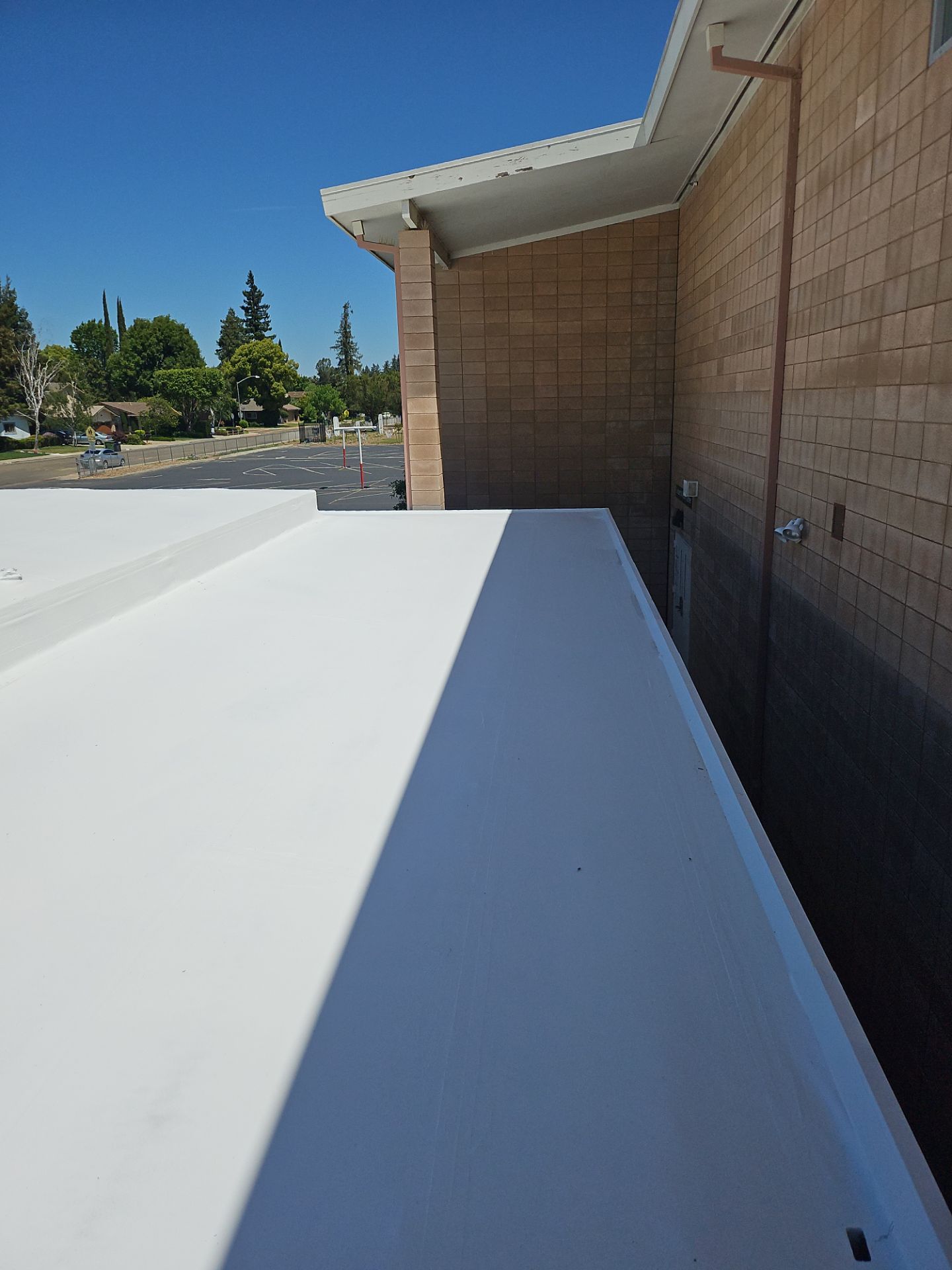 Single-ply restoration system using Benchmark/PUMA XL coatings over TPO single-ply roofing by Straight Edge Roofing Inc