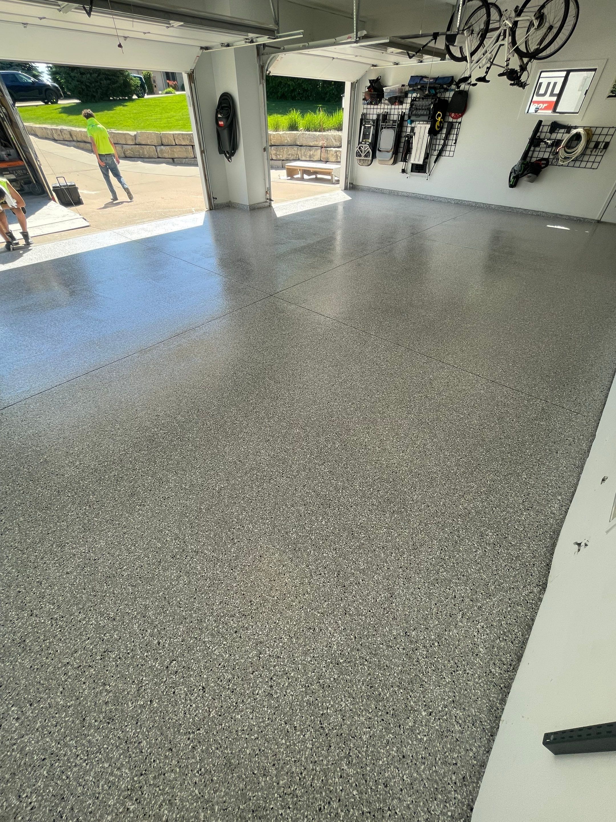 Feather Grey Garage Floor Coating Installation in Sioux Falls by Select Painting, Coatings & Garage Cabinets