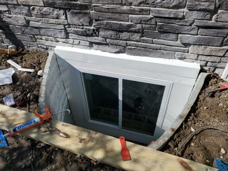 Egress Window Installation using Rockwell Egress Fiberglass Egress Window Well by Toledo Basement Repair 