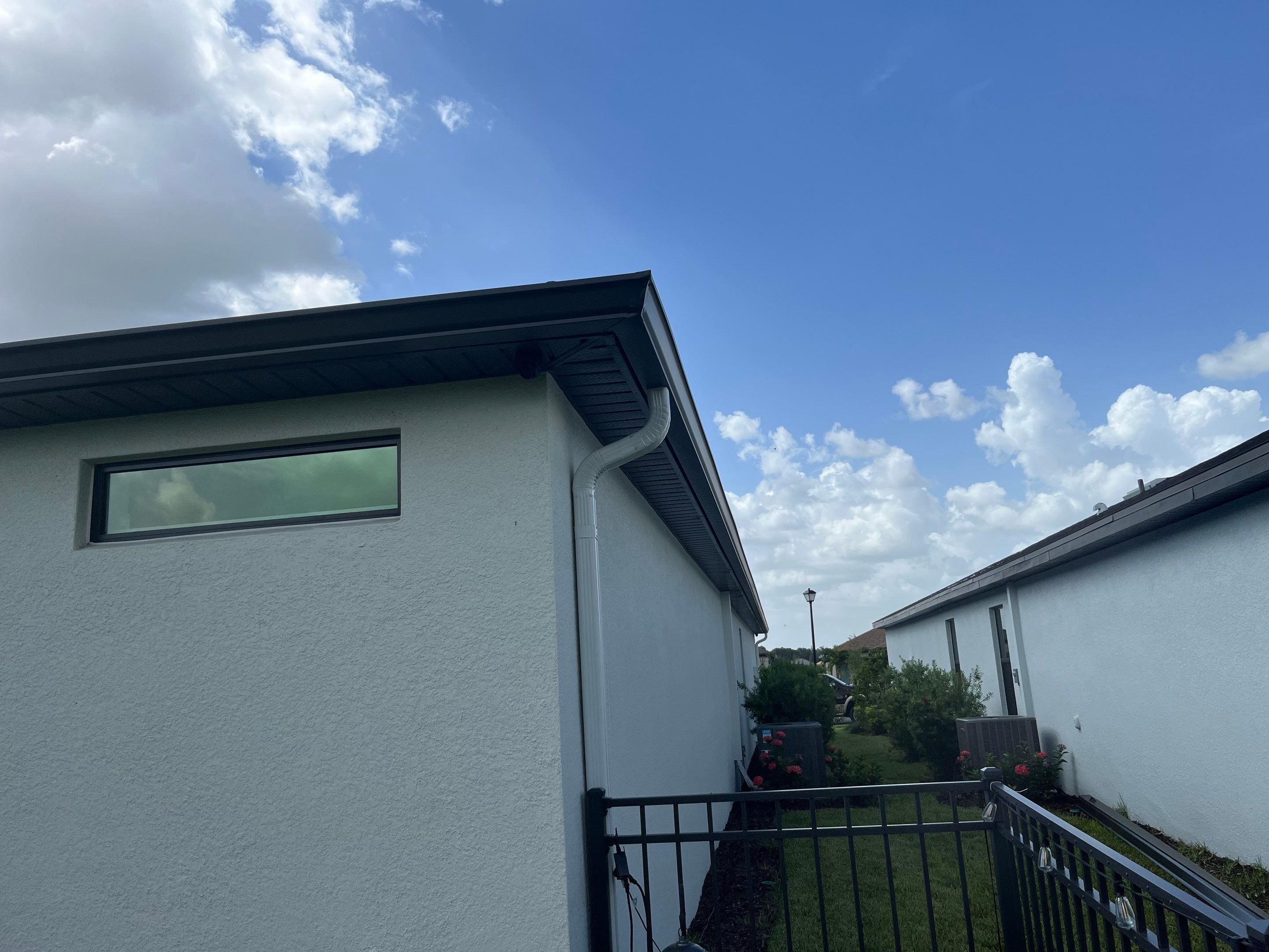 Dark Bronze Gutters and White Downspouts in Sarasota FL by Gutter Professors