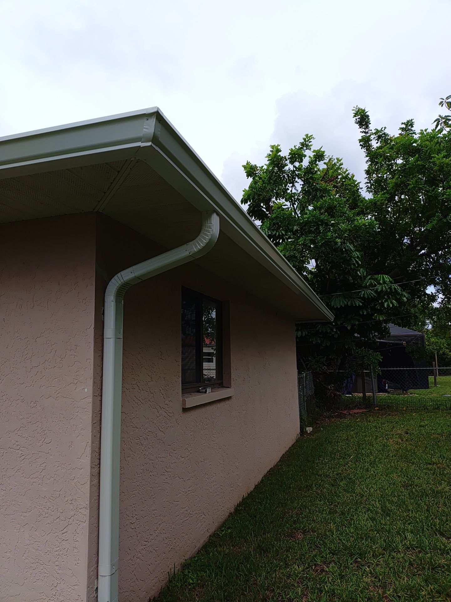 Replace gutter using White Down Spouts in Cape Coral FL by Gutter Professors