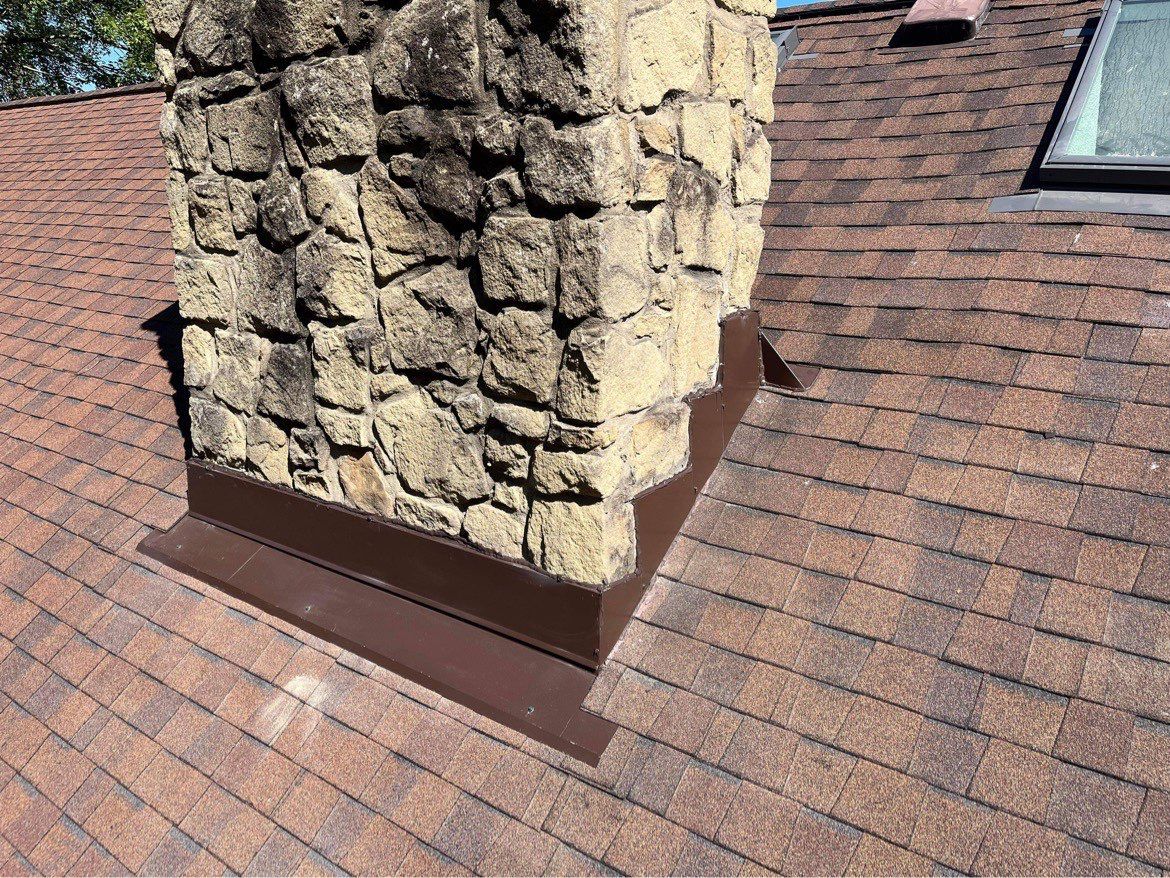 Shingle Roofing with Velux Skylight replacement and stone chimney flashing by Secure Construction Company Inc