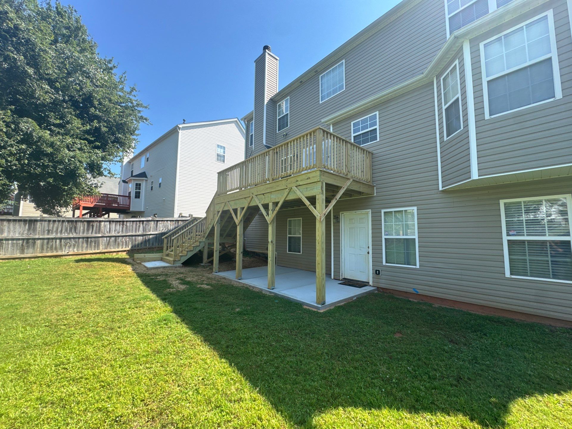 Backyard Deck Expansion & Custom Staircase Installation in Suwanee. by Swift Home Renovations