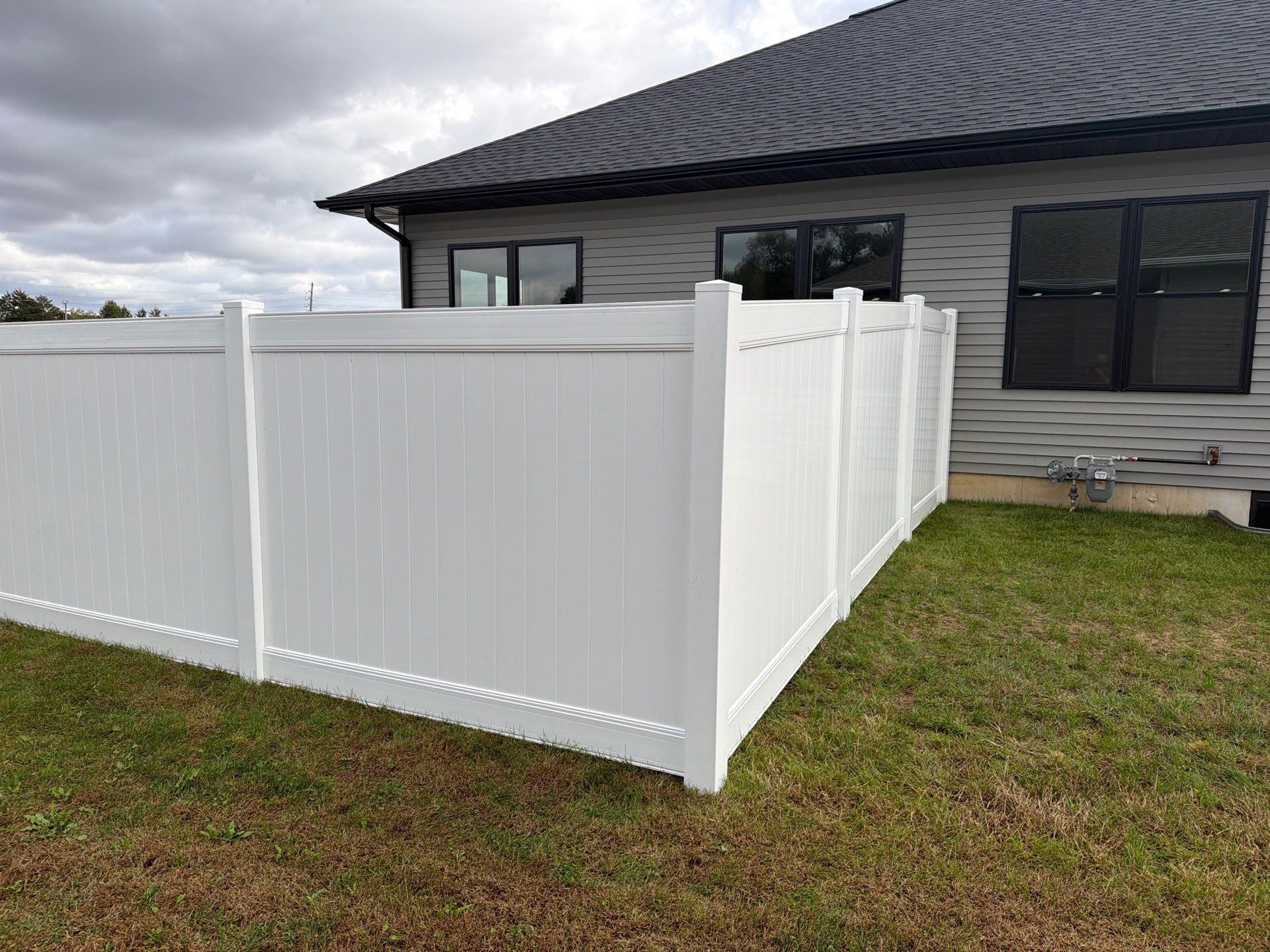 Residential White Vinyl Privacy Fence Installation in Janesville by Perfect Picket Fence and Stain
