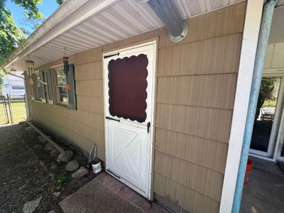 Garage Epoxy Flake Floor Installation and Exterior Siding Repairs in Muskegon