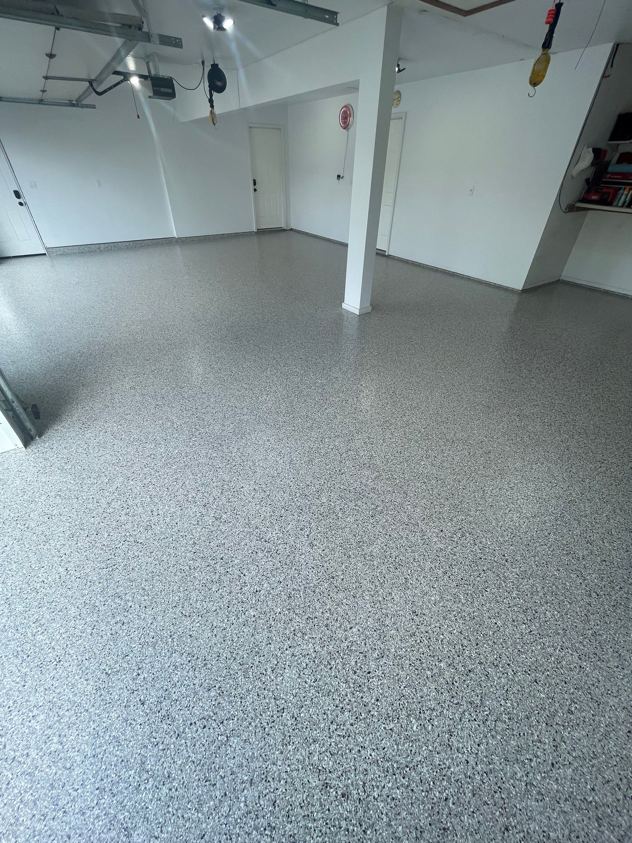 Multi-Car Garage Concrete Coating with Coyote Flake Finish in Sioux Falls by Select Painting, Coatings & Garage Cabinets
