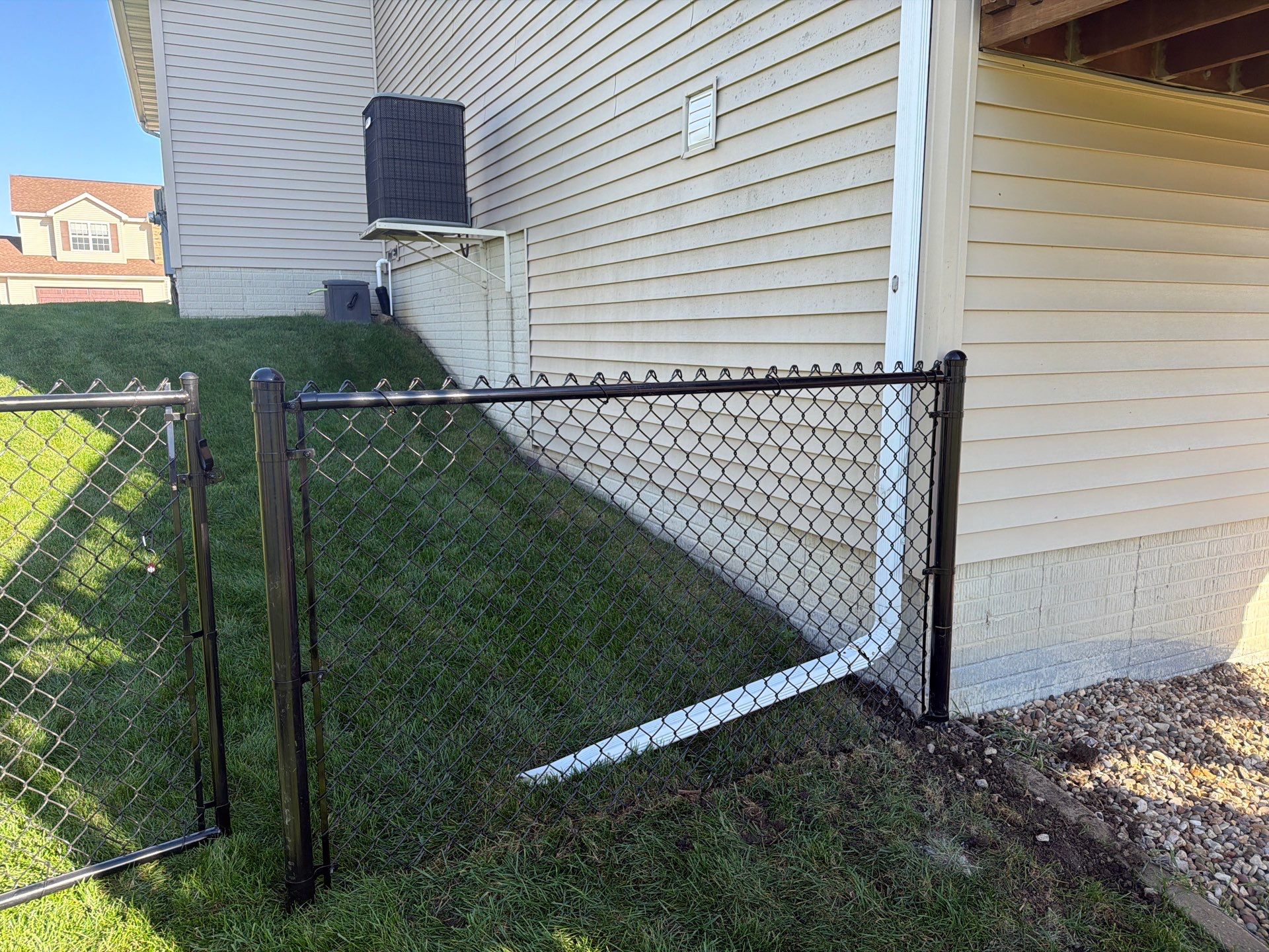 Black Vinyl-Coated Chain Link Fence Installation in Cedar Falls by Perfect Picket Fence and Stain