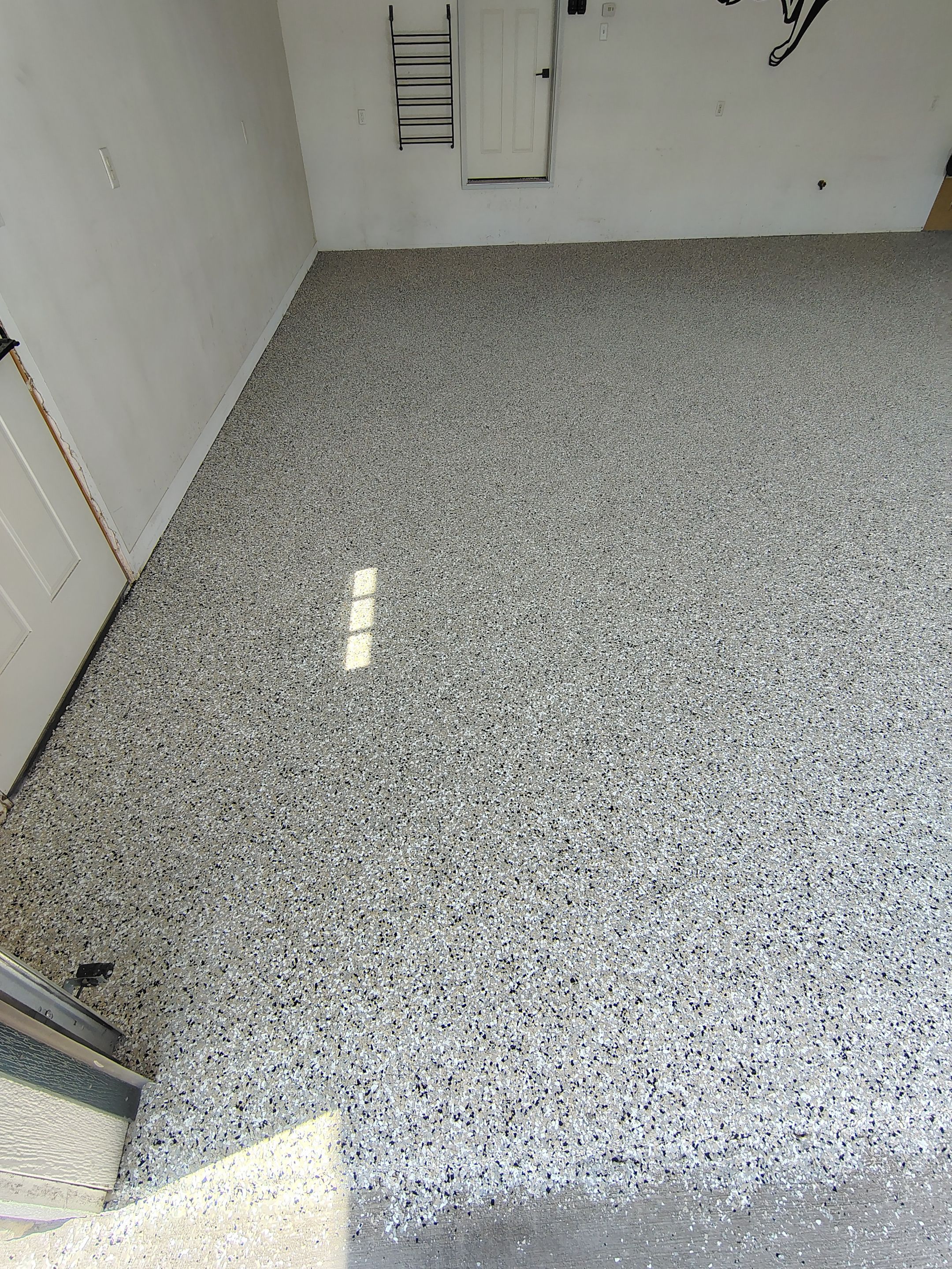 Speckled Polyaspartic Garage Floor Coating Installation in Dell Rapids by Select Painting, Coatings & Garage Cabinets