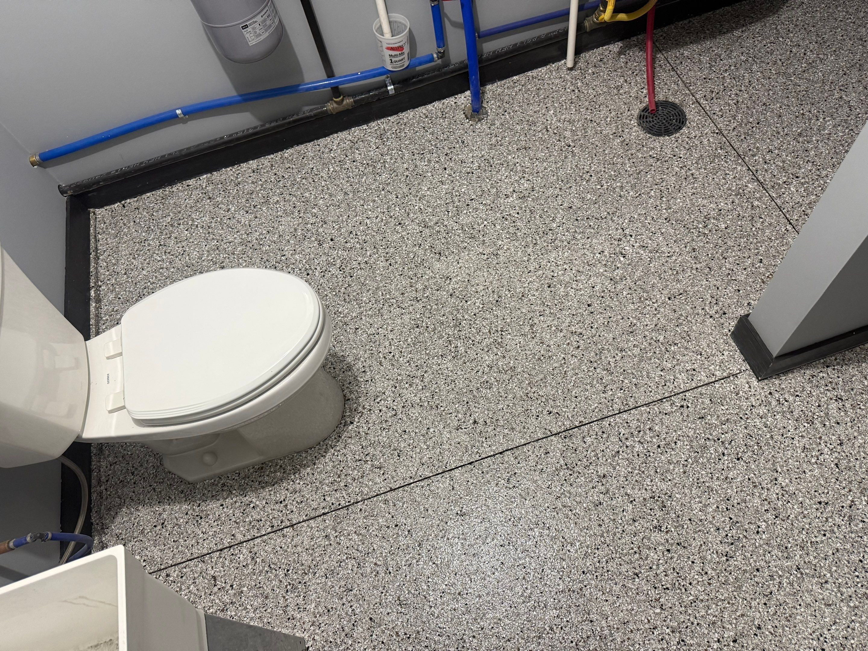 Polyaspartic Garage Floor Coating with Decorative Flake in Wentworth by Select Painting, Coatings & Garage Cabinets