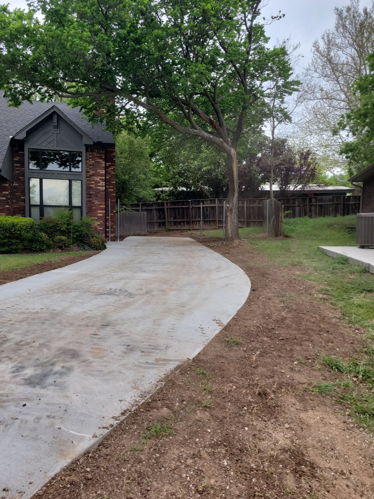 Concrete Driveway and Fence by Clays Services Inc