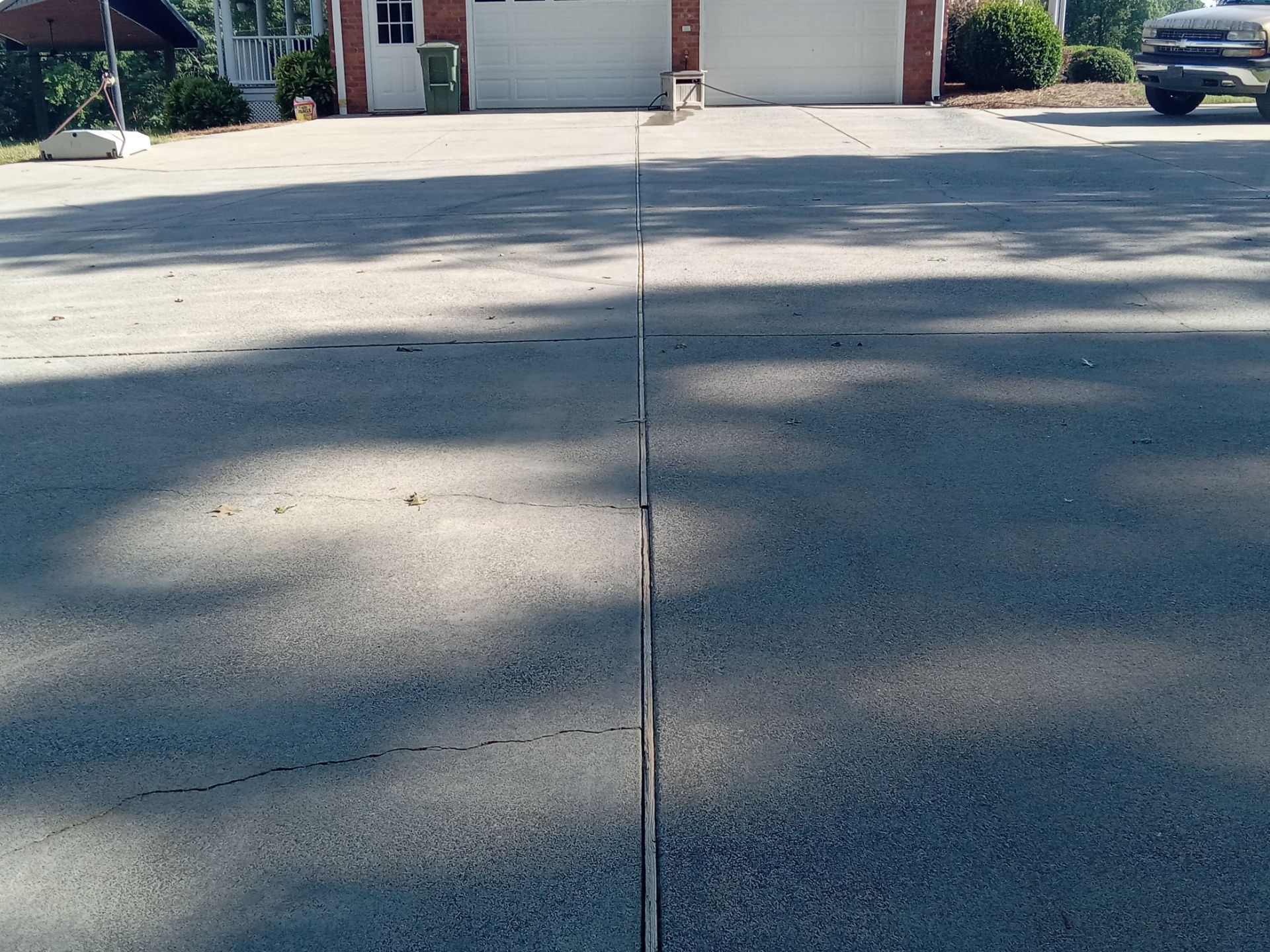 pressure washing driveway cleaning dirt buildup removal surface restoration improving curb appeal