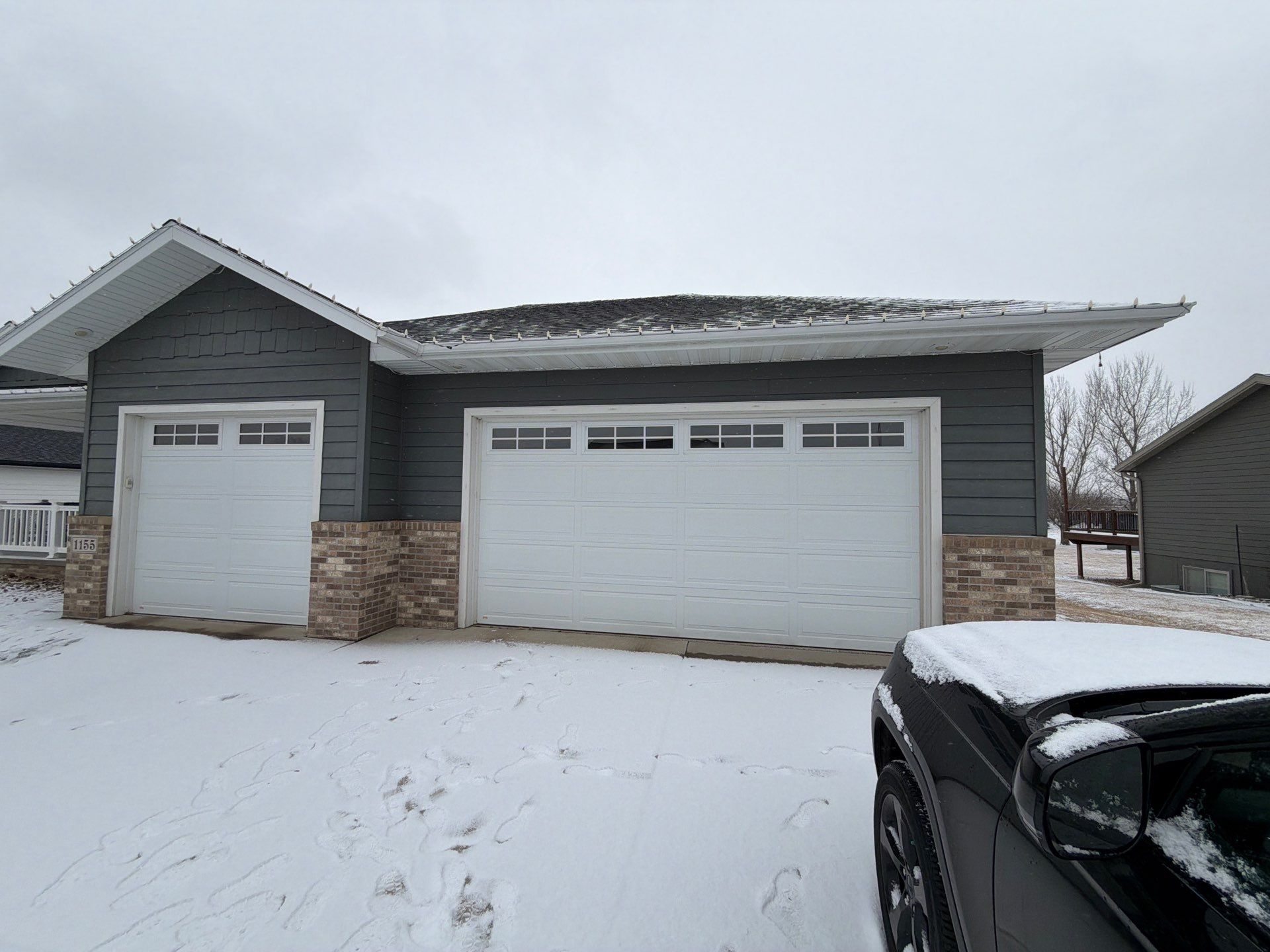 Madison Exterior Remodel with Dark Gray Siding and Stone Accents by Select Painting, Coatings & Garage Cabinets