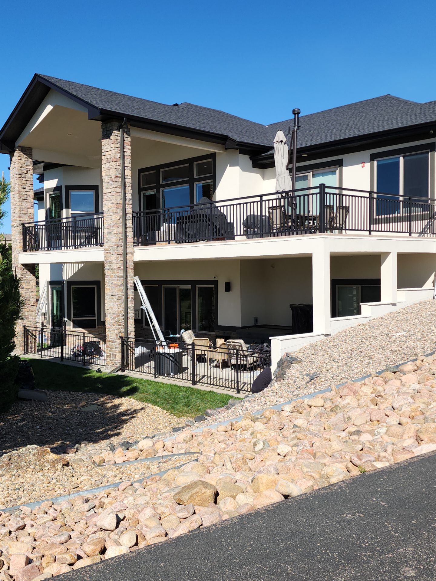 Castle Rock Elegance: White Stucco Exterior with Bold Tricorn Black by J&M Painting LLC