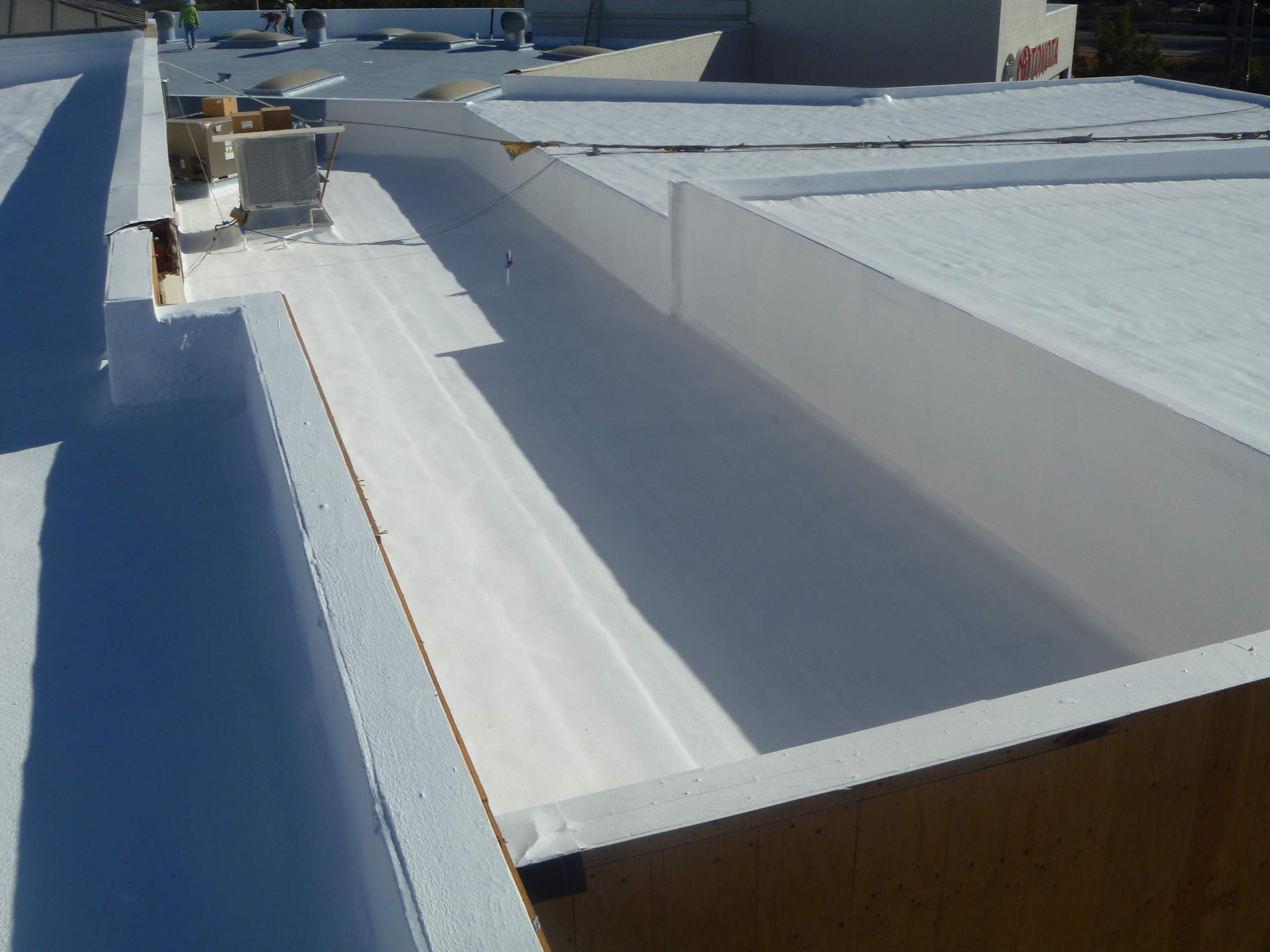 Commercial Roofing Installation using Spray foam and Conklin Benchmark/PUMA XL 18 yr warranty coatings by Straight Edge Roofing Inc