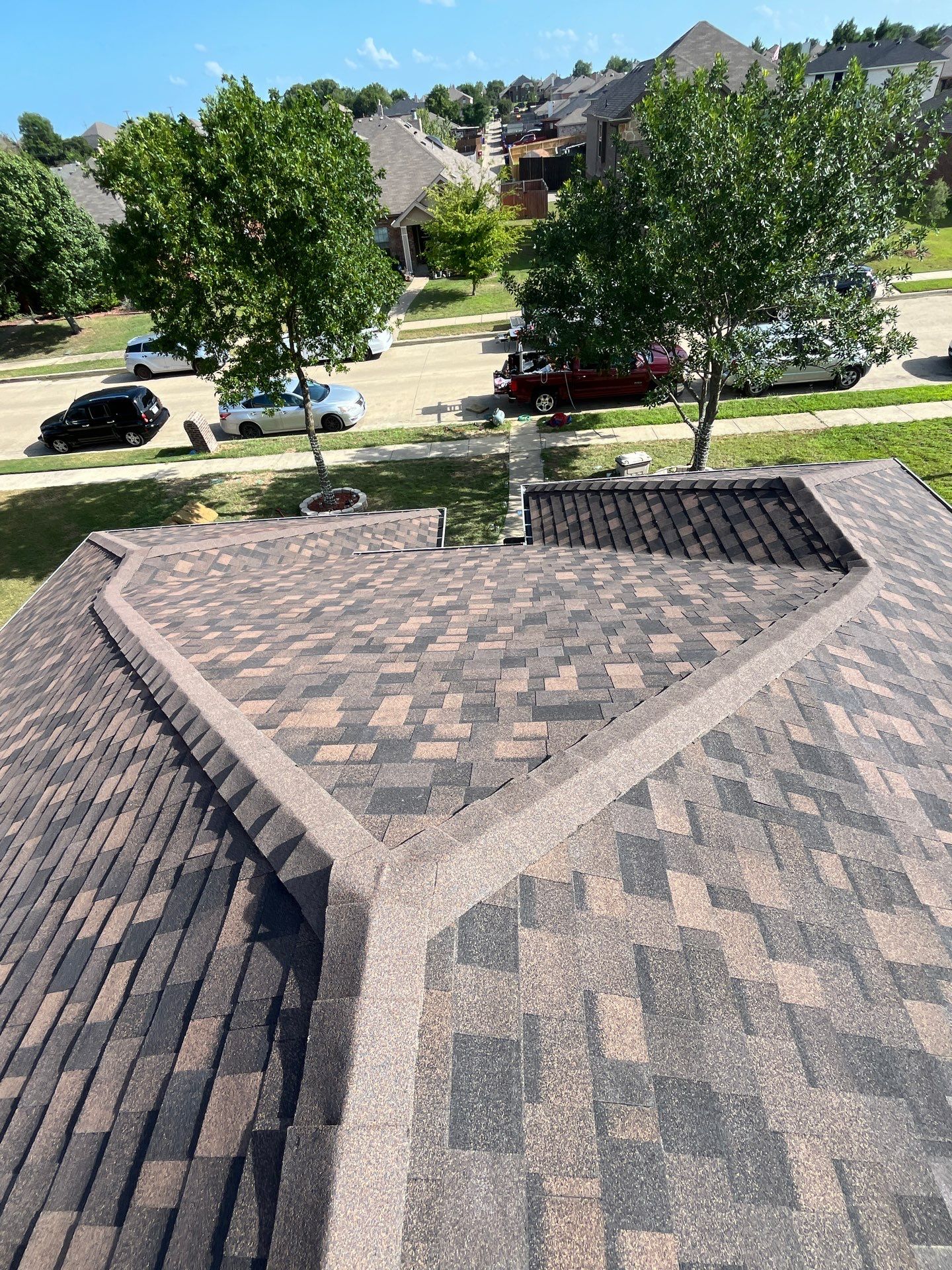 IKO Shadow Brown-Medium brown brick house by Tejas Roofworks + Restoration