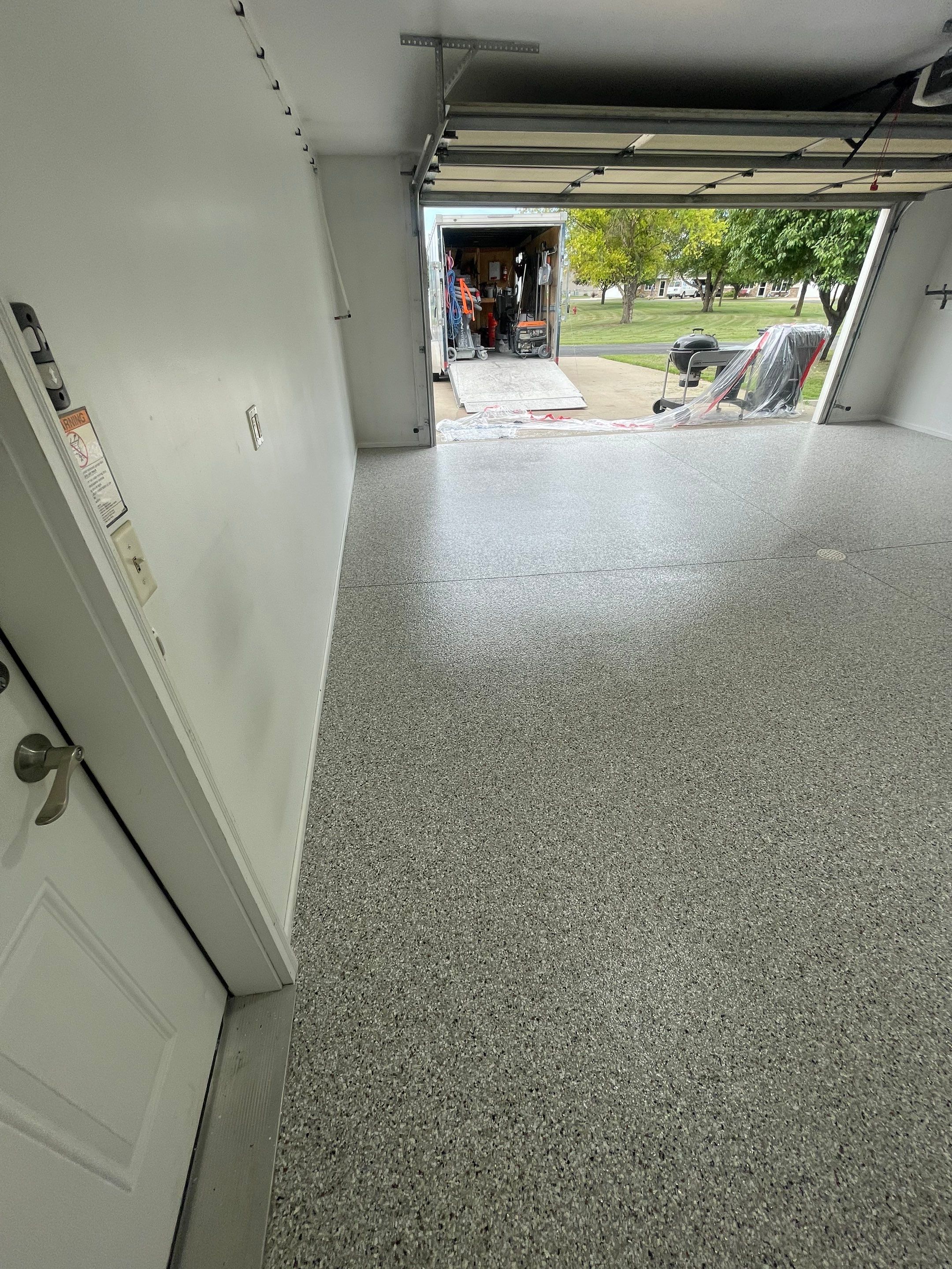 Coyote Flake Garage Floor Coating in Worthington, Minnesota by Select Painting, Coatings & Garage Cabinets