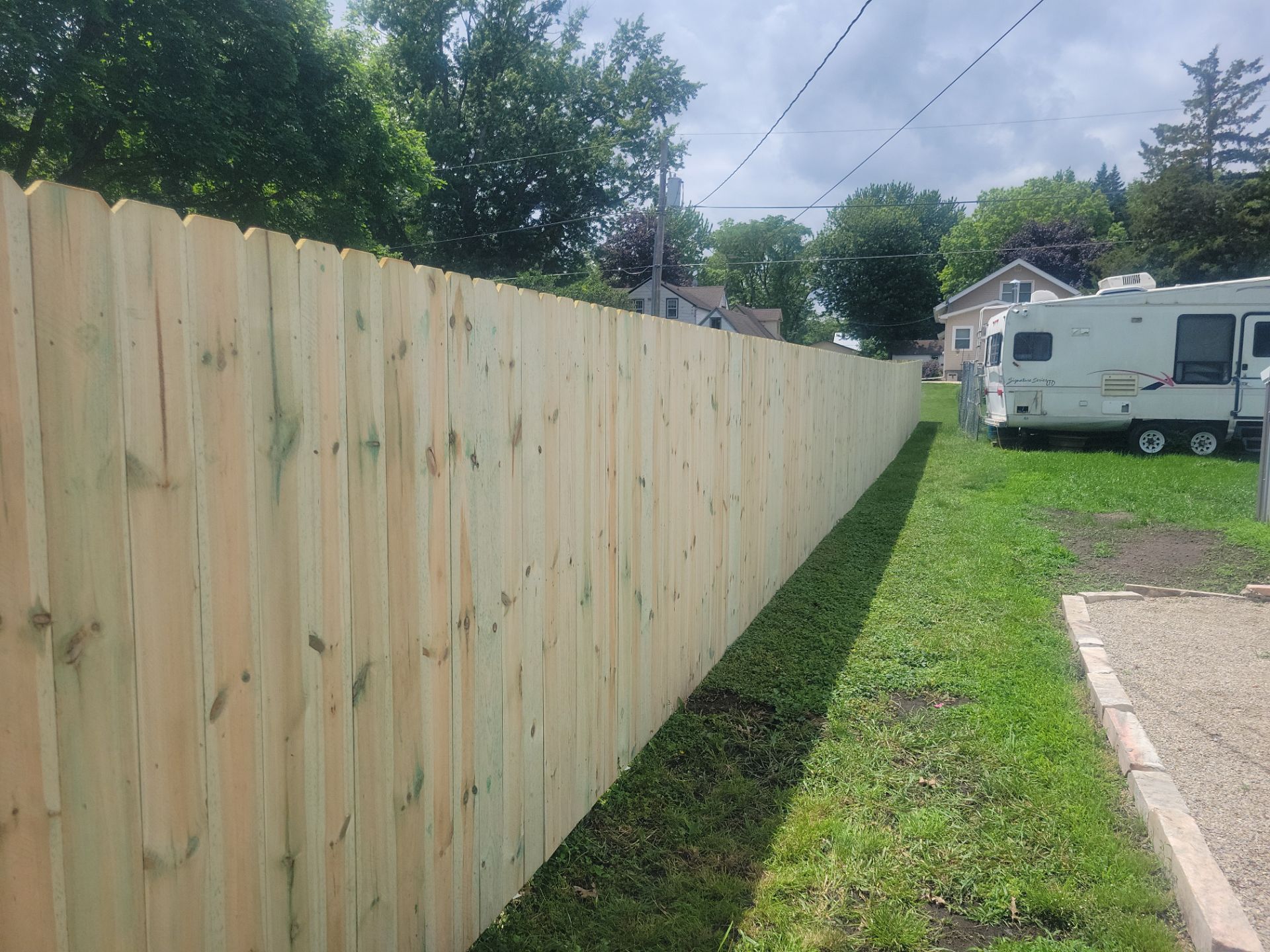 Pressure-Treated Wood Privacy Fence Installation in Charles City by Perfect Picket Fence and Stain