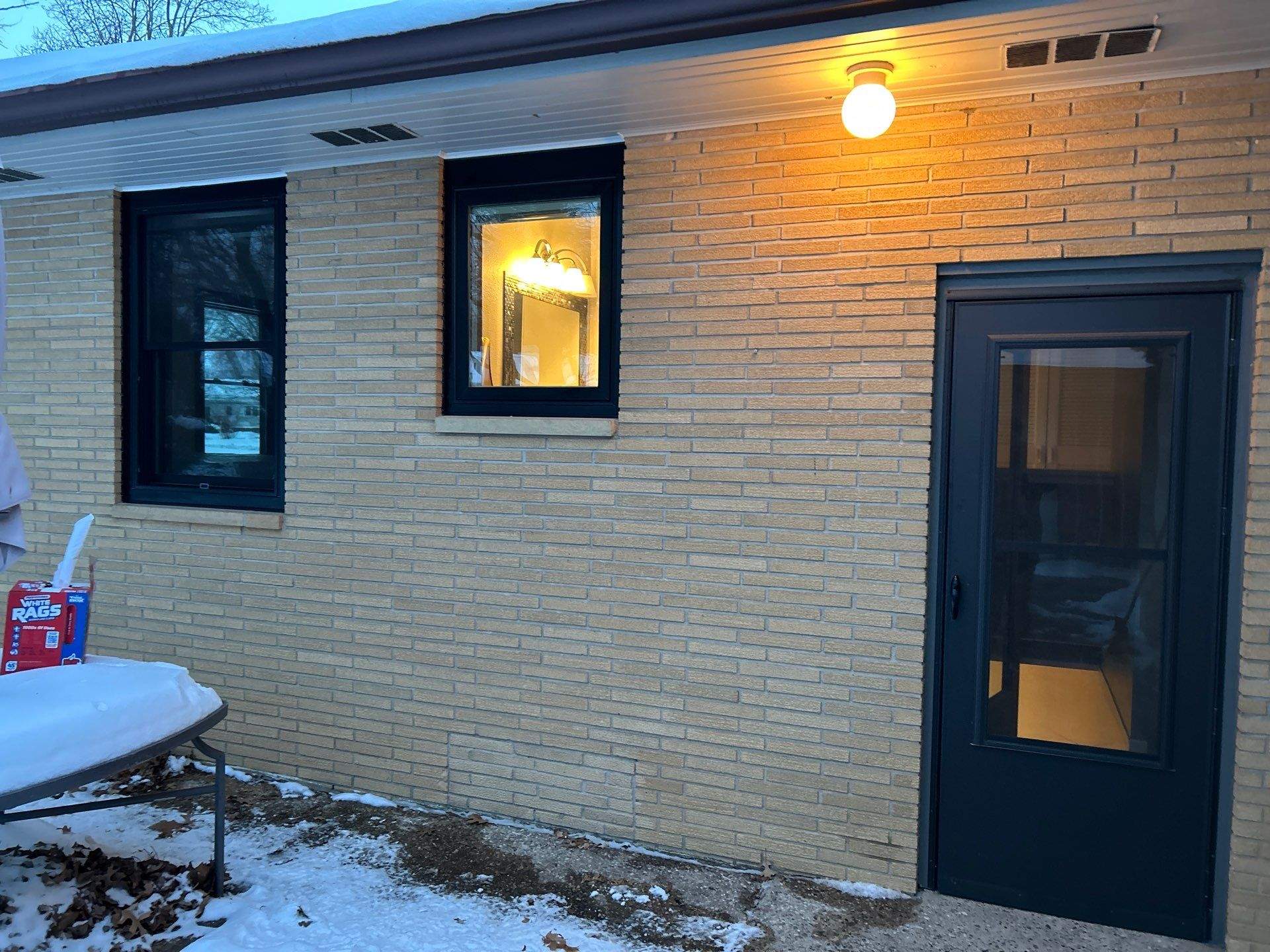 Black-Frame Pella Lifestyle Upgrade on a Partial Brick Home by United Windows and Siding LLC