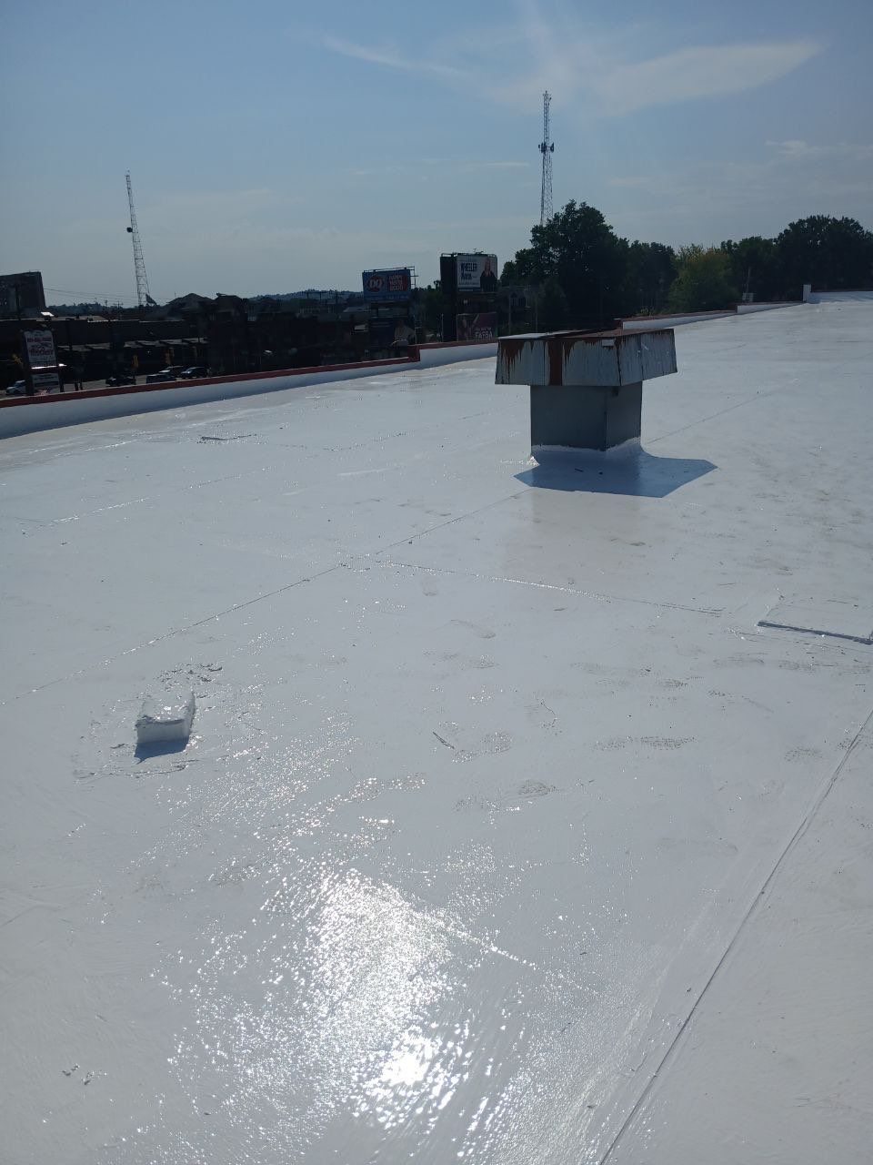 Commercial Roofing Installation using smartcoat Roof coating by Fahey Roofing + Contracting