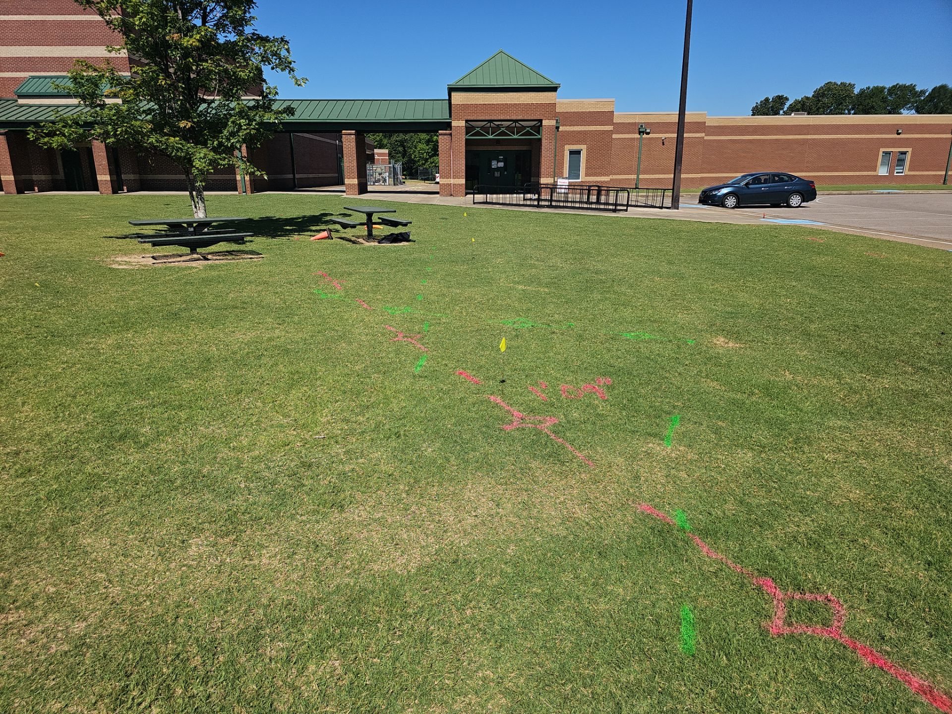 Utility Locating at a school for fence install by Alsip Locating Service, LLC