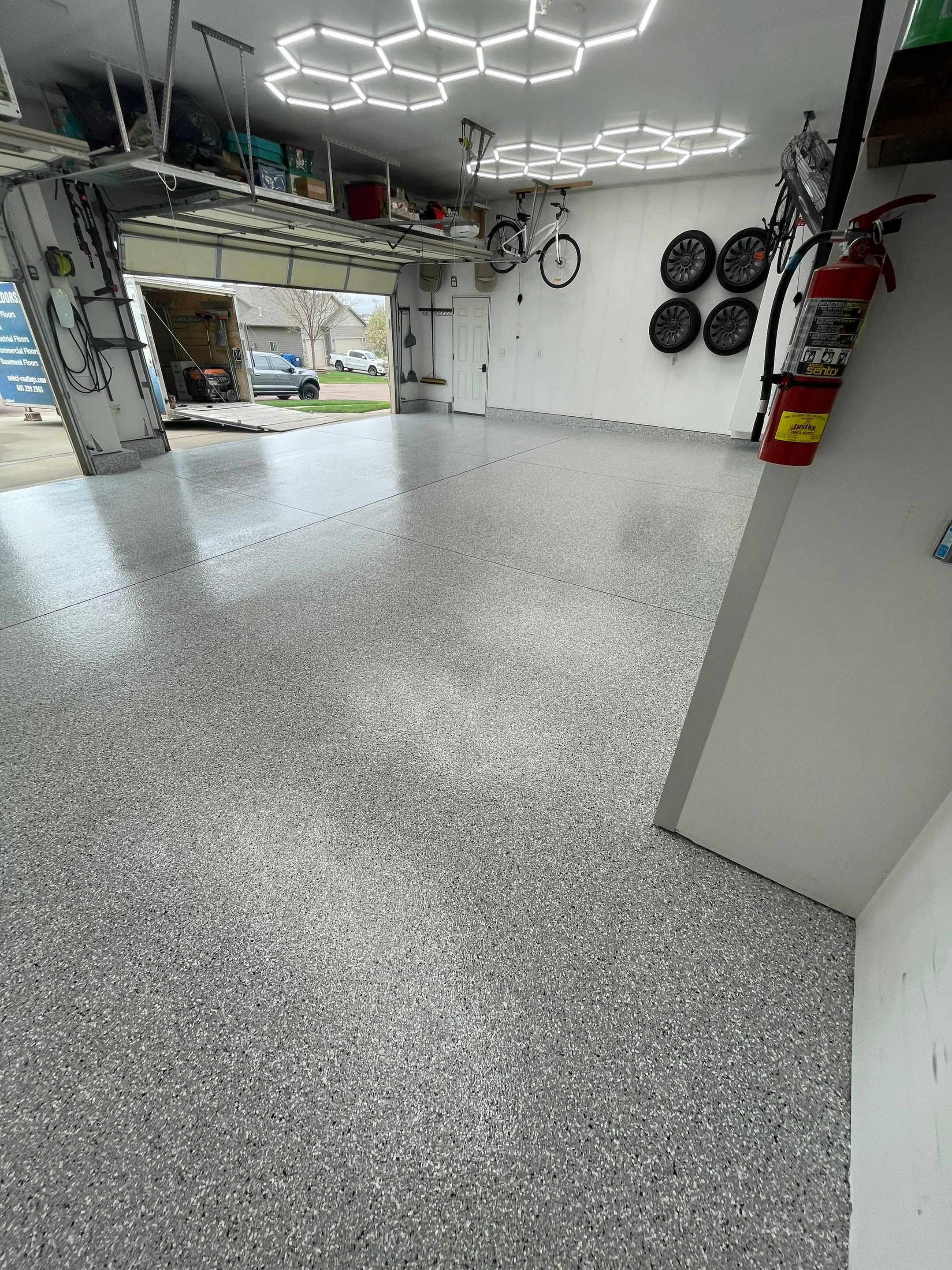 Feather Gray Epoxy Floor Coating Installation in Sioux Falls by Select Painting, Coatings & Garage Cabinets