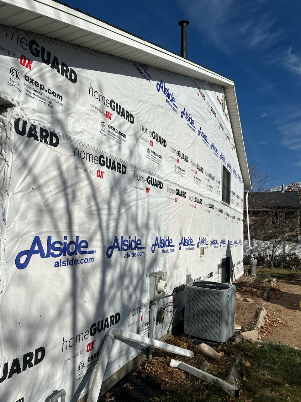 Aluminum Siding Replacement with Blue Dutch Lap Vinyl Siding and White Trim by ASAP Roofing & Exteriors