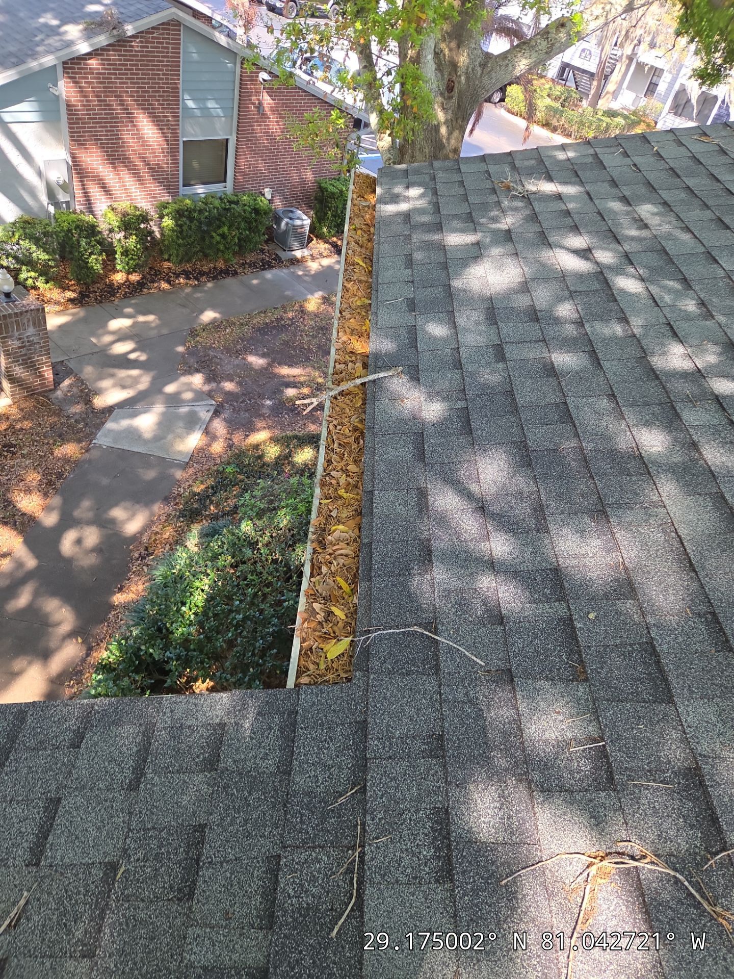 Commercial gutter cleaning Daytona Beach before photo with filled gutters