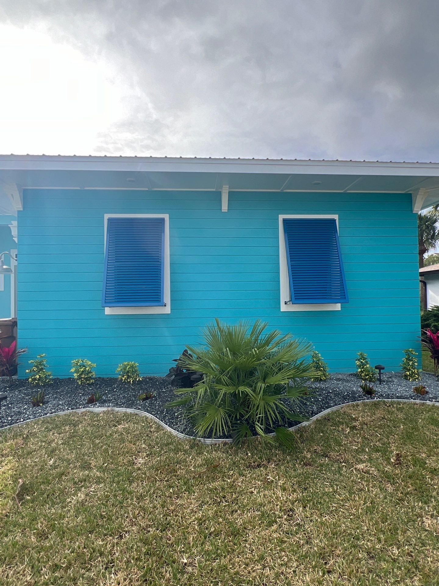 Bahama Shutters in Capri Blue by Smart Guard Shutters