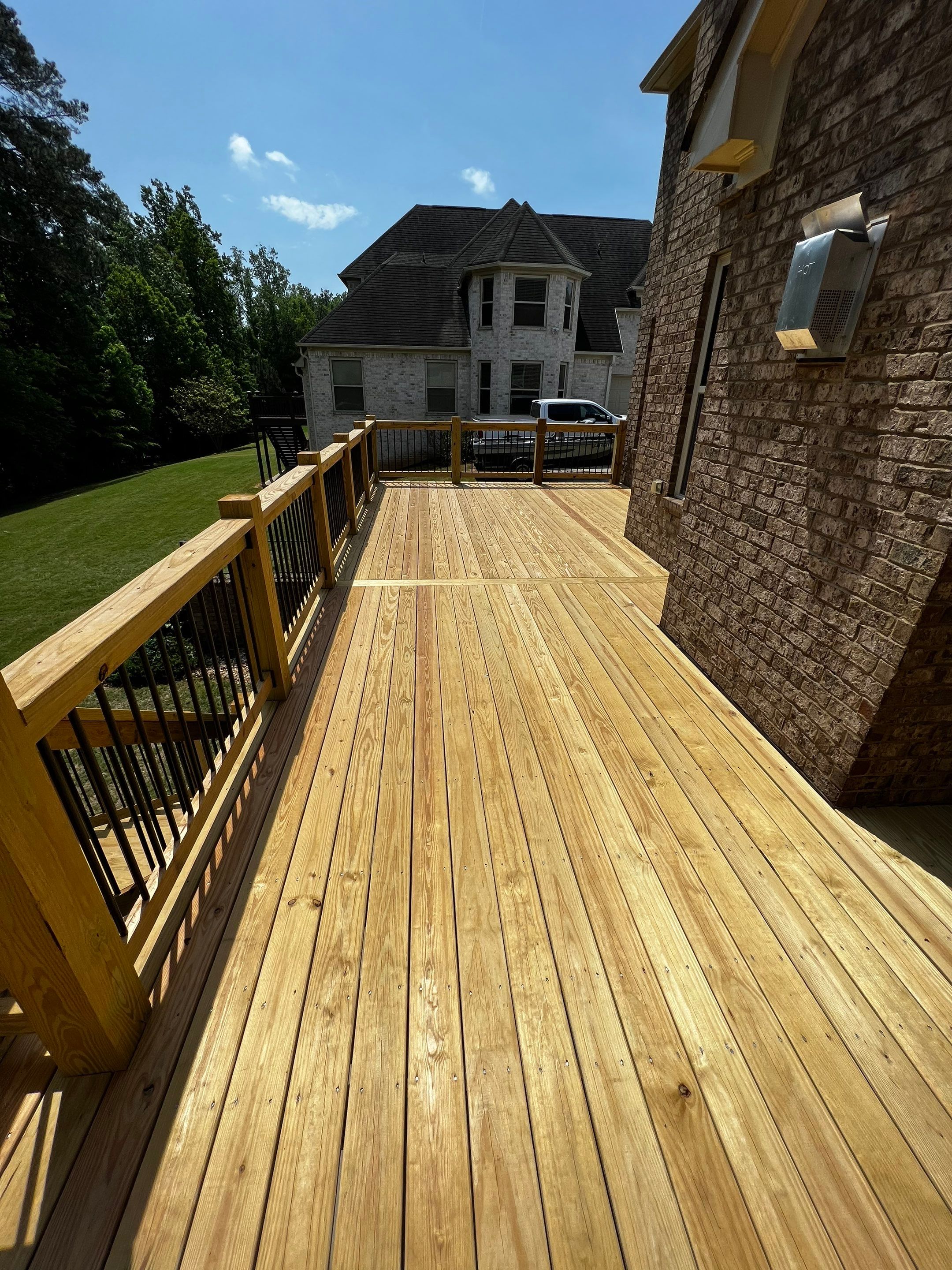 Elevated Pressure-Treated Wood Deck and Staircase in Hampton by Swift Home Renovations