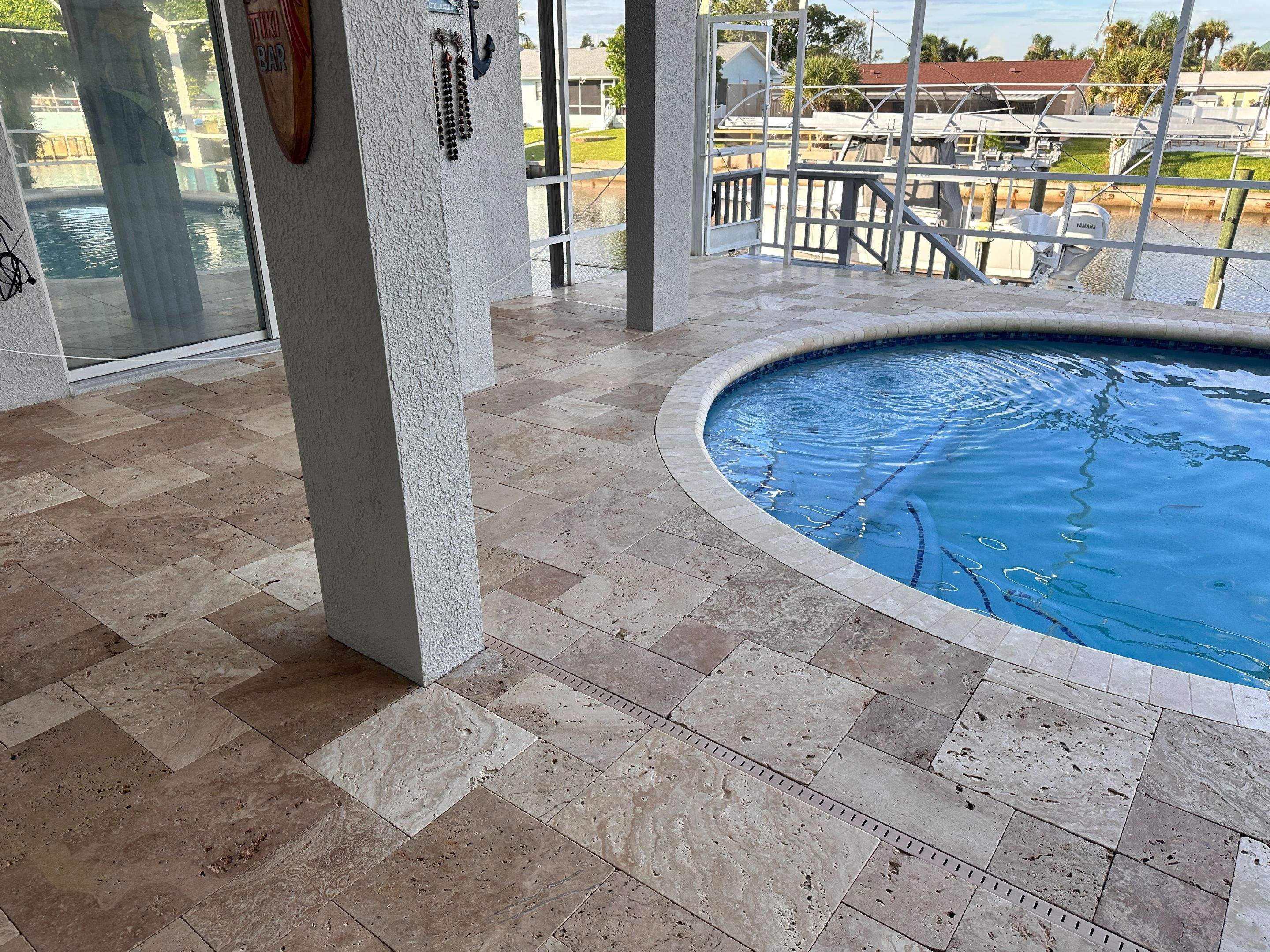 Travertine Sealing and Stripping for a Waterfront Pool Deck in Apollo Beach by Supreme Paver Experts