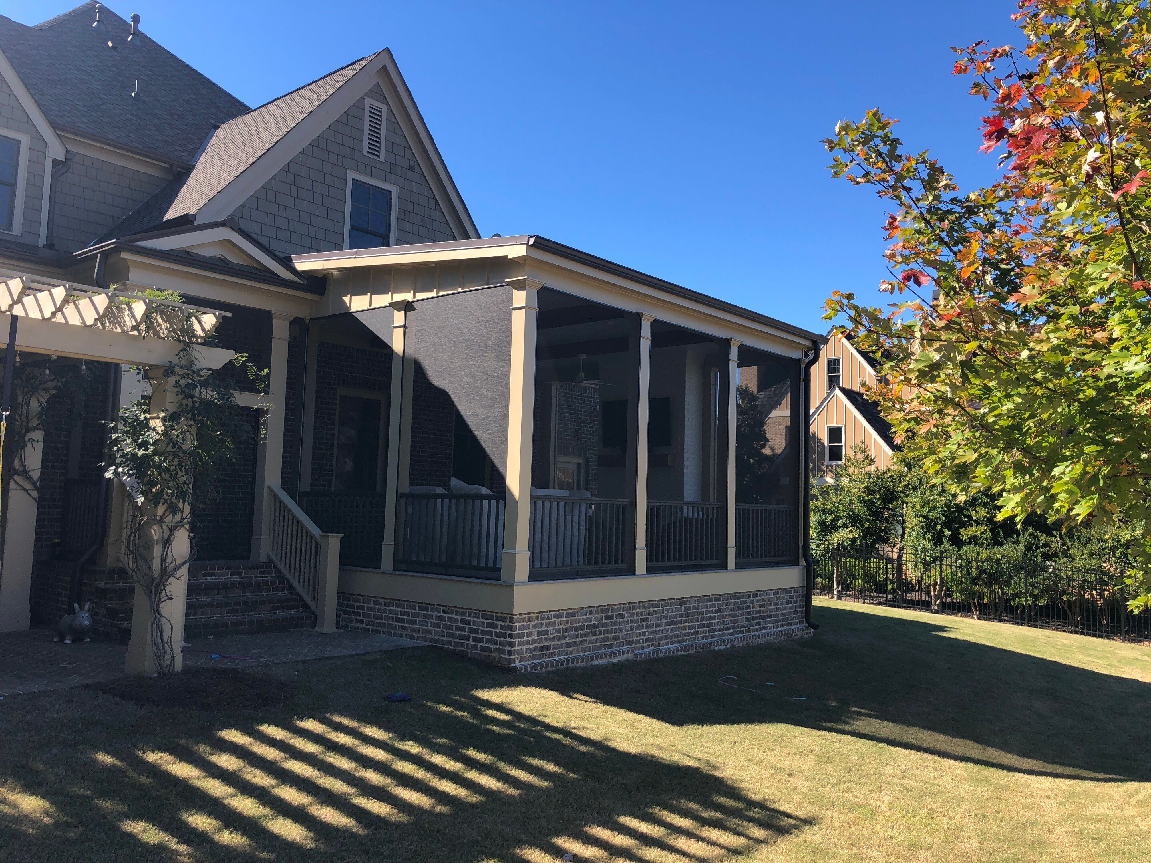 Custom Screened Porch Addition with White Brick Fireplace in Duluth by Swift Home Renovations