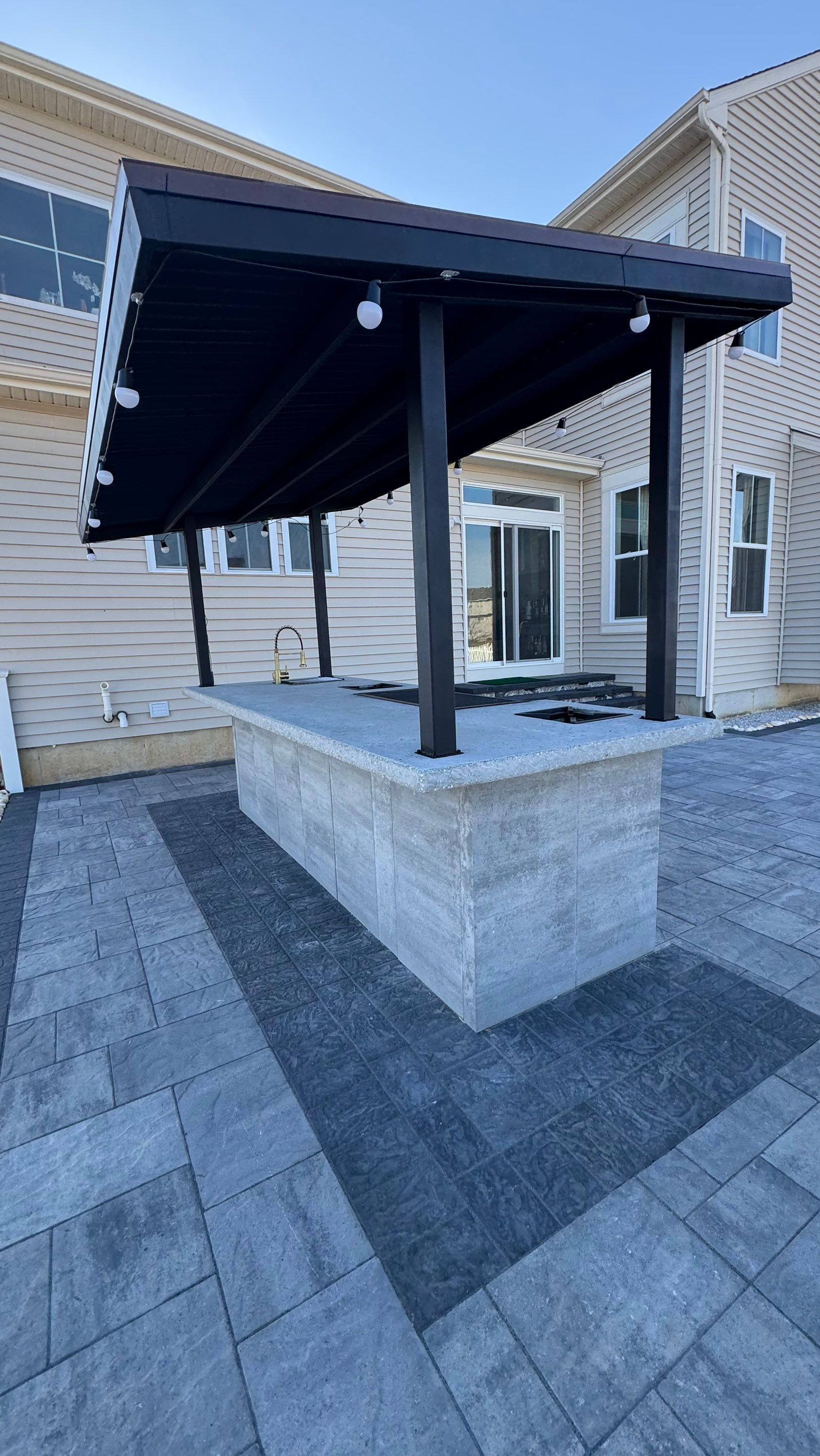 Custom Belgard patio by Studio G Indoor Spaces & Outdoor Living