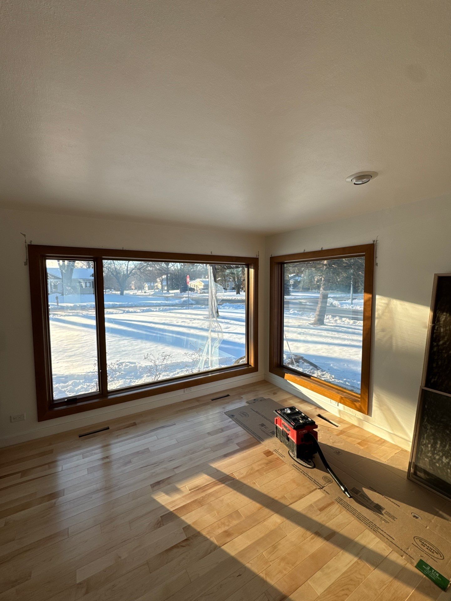 Black-Frame Pella Lifestyle Upgrade on a Partial Brick Home by United Windows and Siding LLC