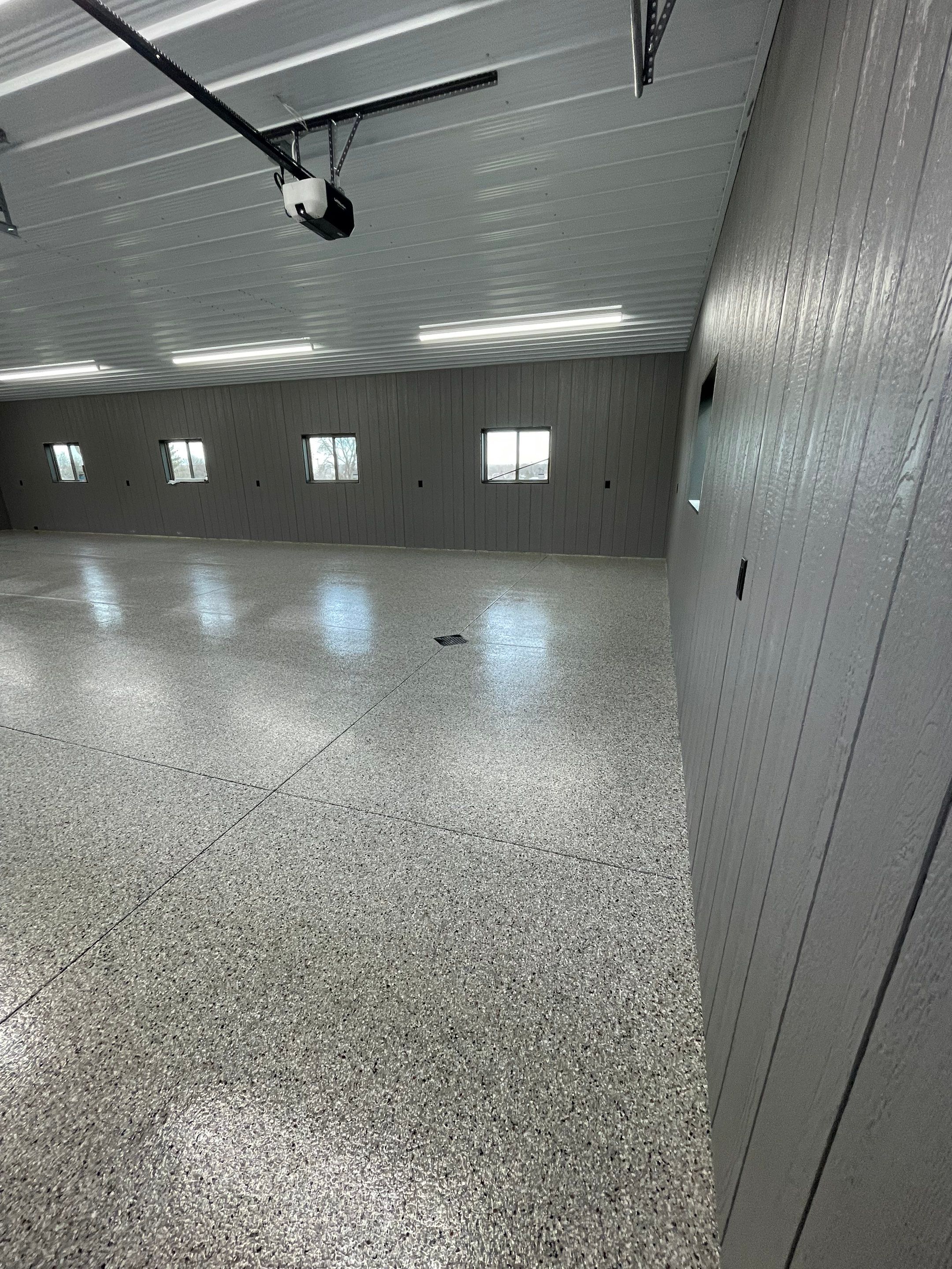 Speckled Epoxy Floor Coating for Large Shop in Rock Valley by Select Painting, Coatings & Garage Cabinets