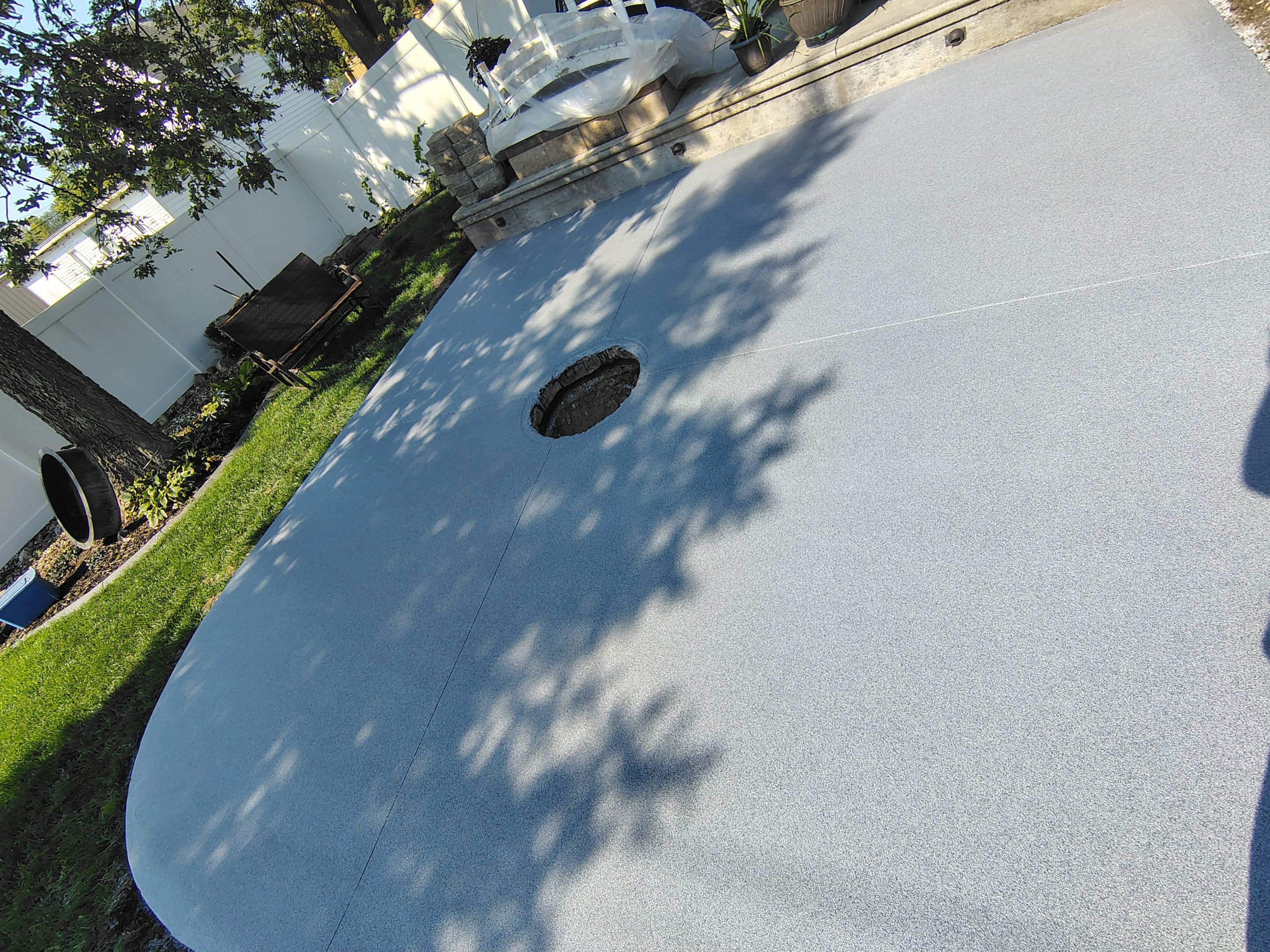 Custom Garage Floor Coating and Backyard Patio Refinishing in Tyndall by Select Painting, Coatings & Garage Cabinets