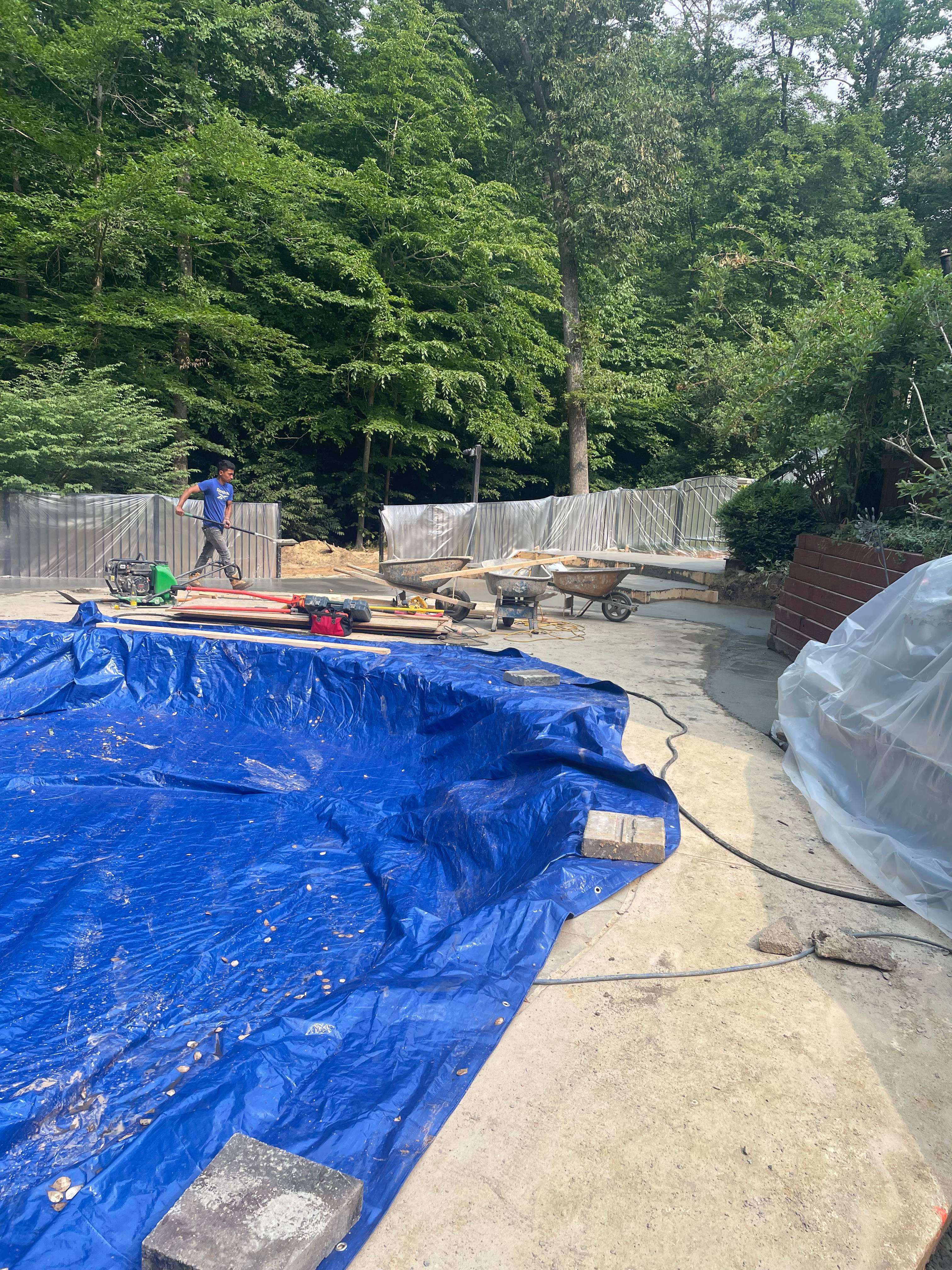 Pool Surround remodel with retaining walls, new waterfall and water slide by Fairfax Contractors, LLC