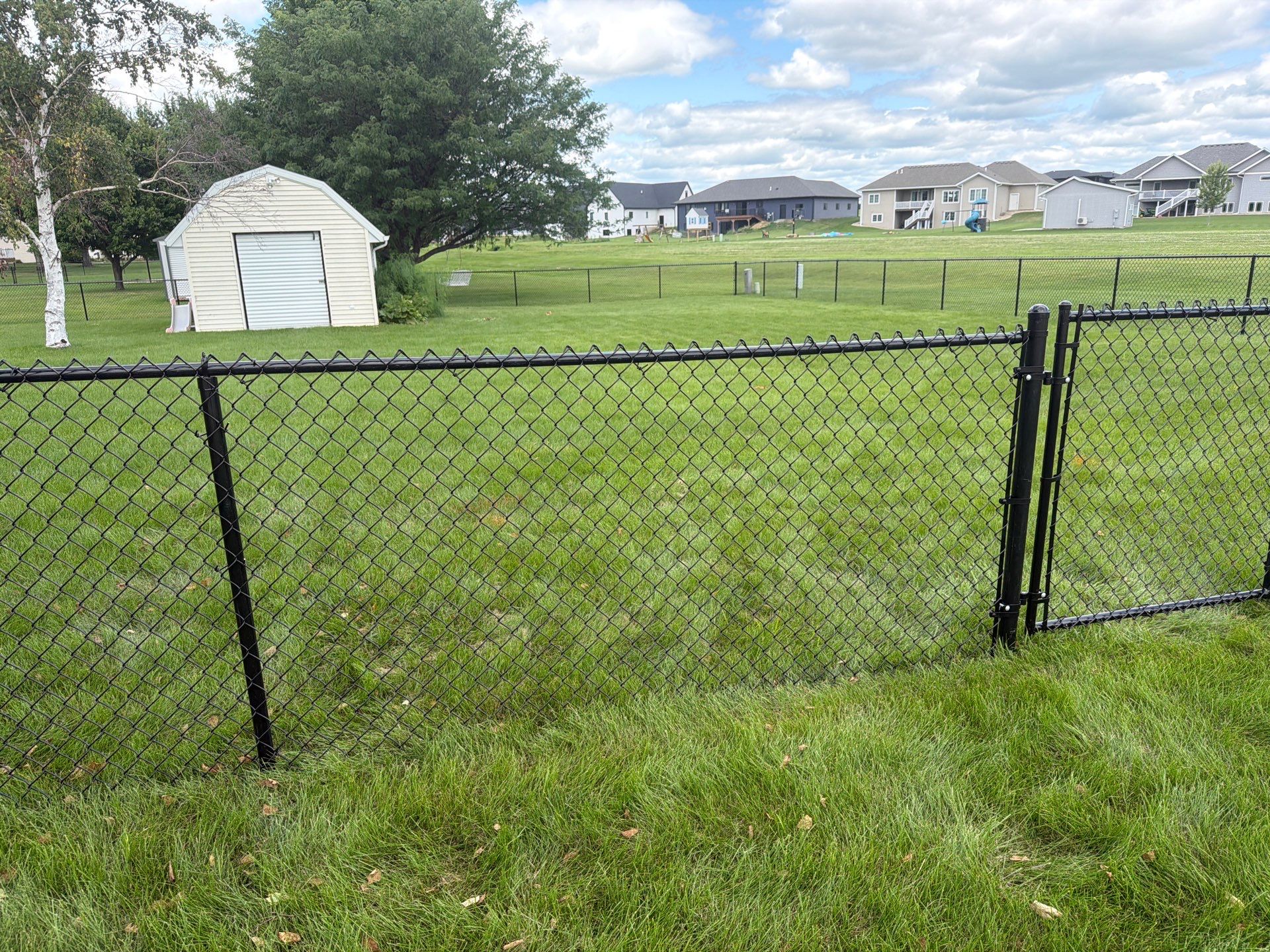 Black Vinyl-Coated Chain Link Fence Installation in Fairbank by Perfect Picket Fence and Stain