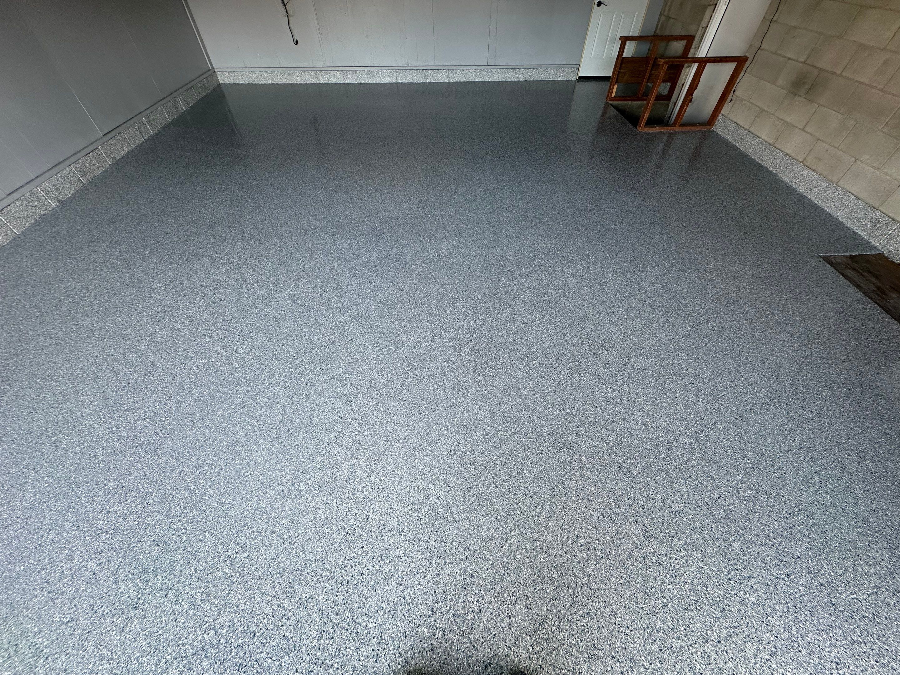 Multi-Colored Speckled Concrete Floor Coating Installation in Sioux Falls by Select Painting, Coatings & Garage Cabinets