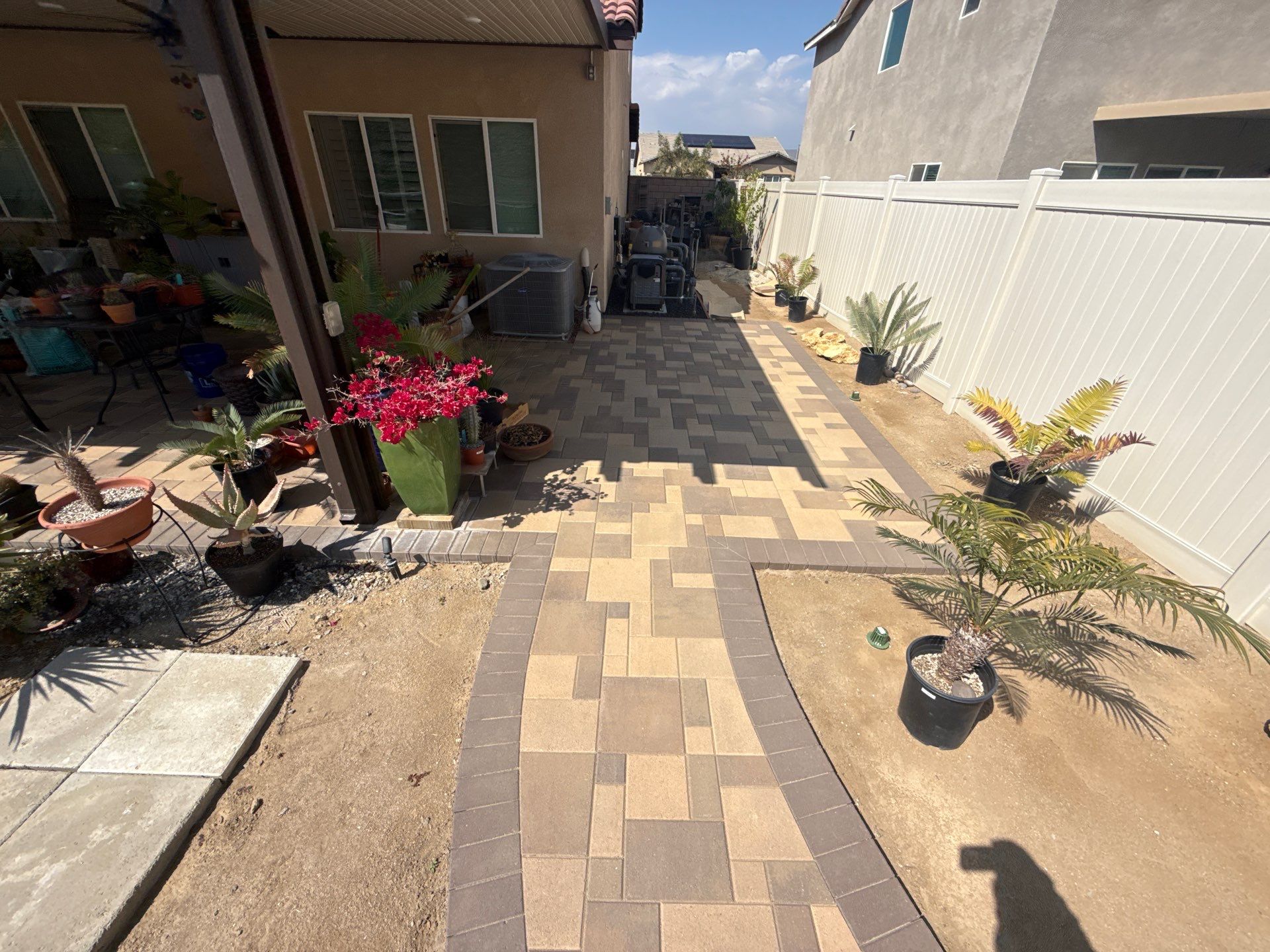 Freeform pool and spa with paver decking by Premier Pools and Spas Temecula