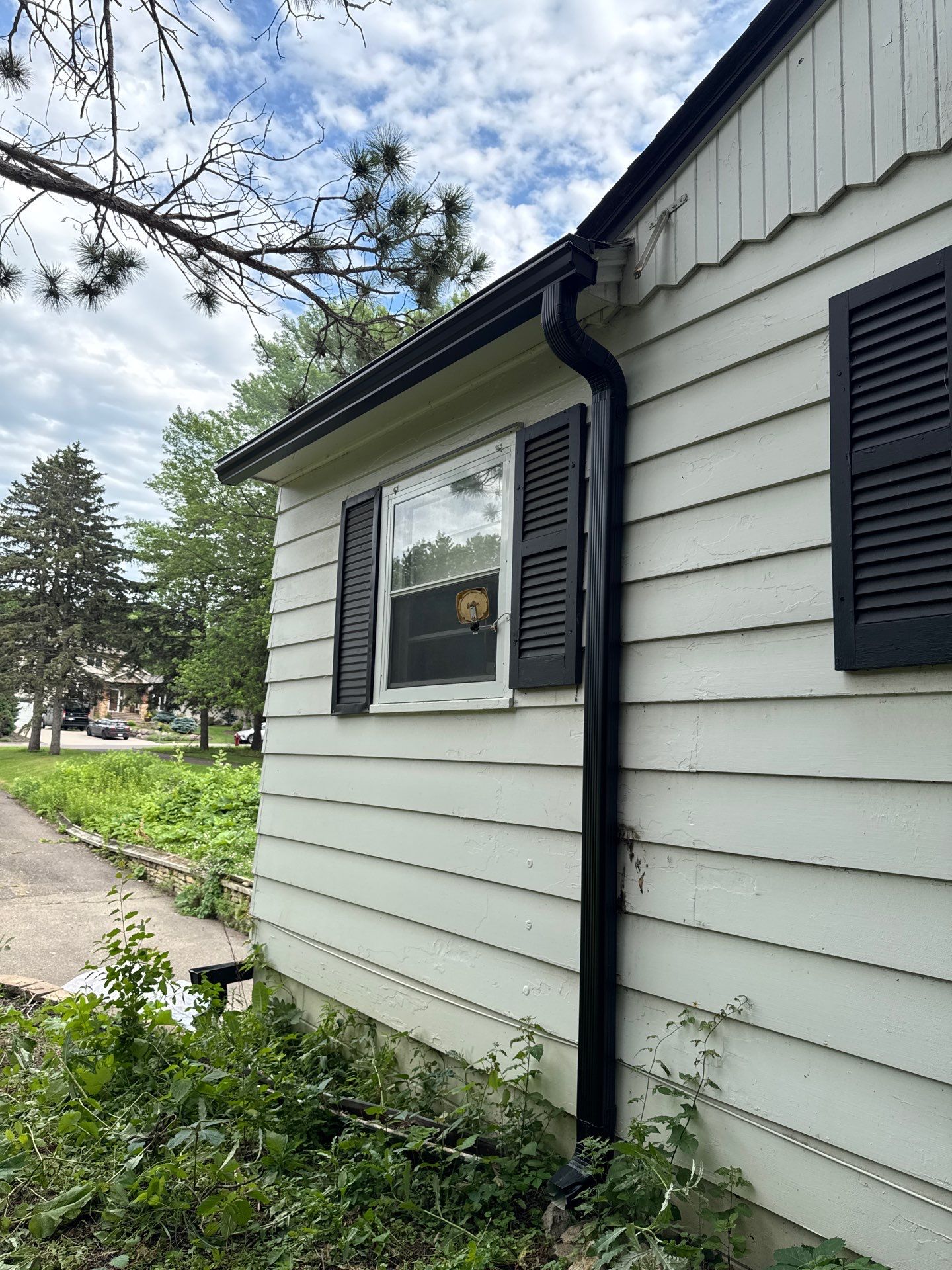 Eagan - Black Seamless Gutters with Helmet Style Guards by Forever Fortified