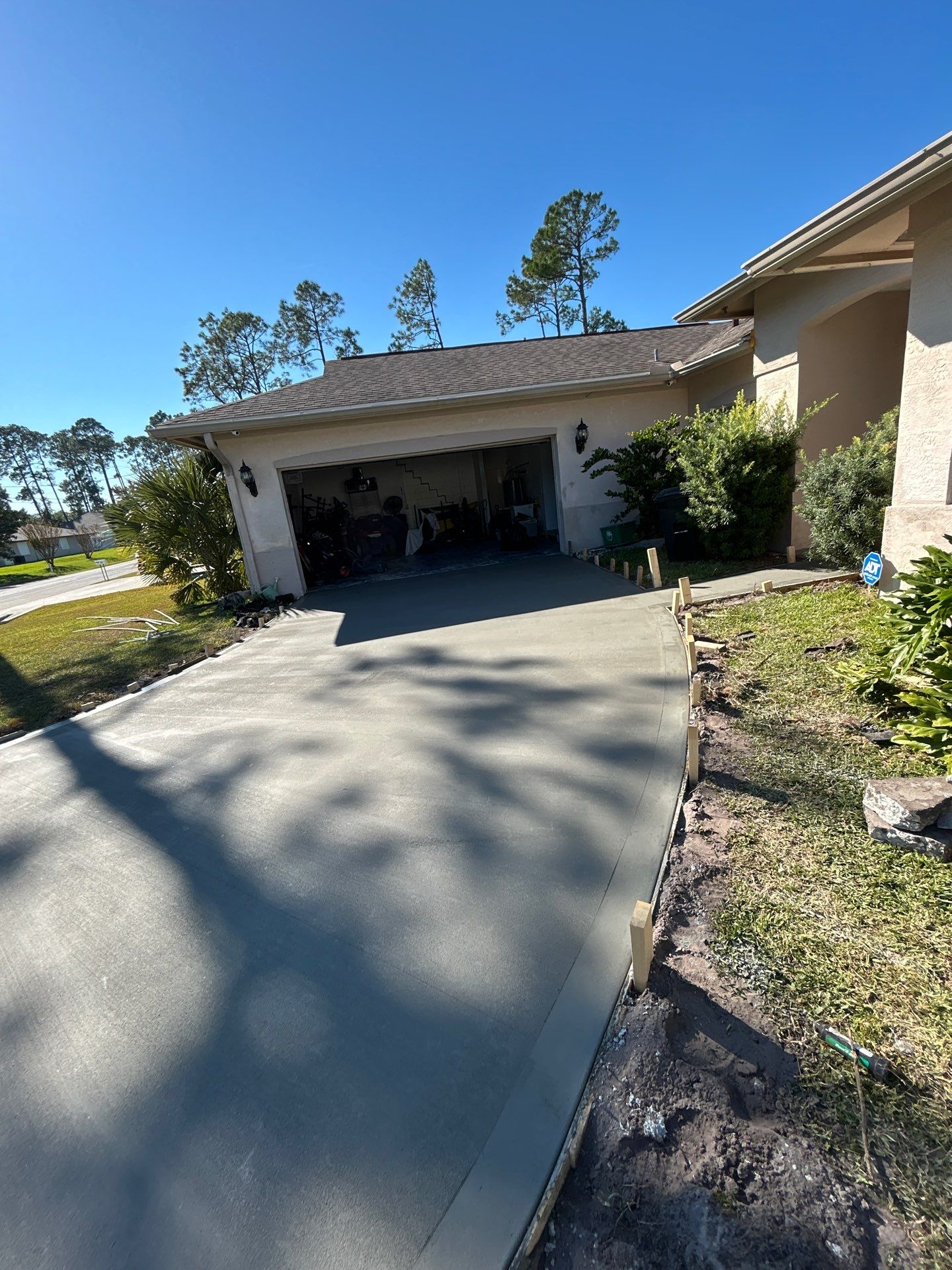New concrete driveway by Courtesy screening