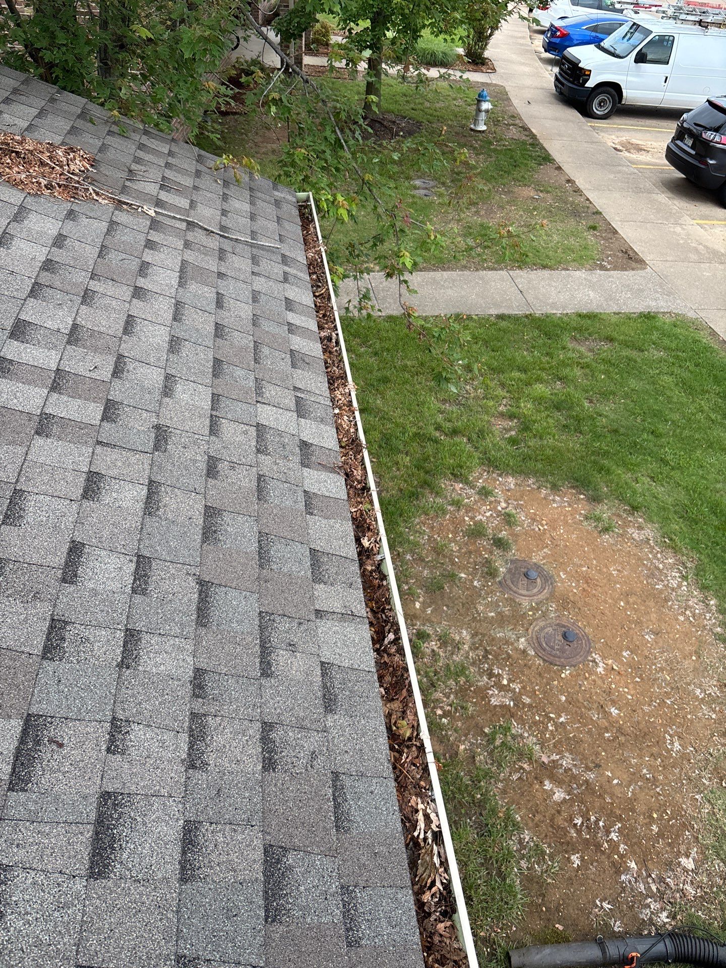 Commercial gutter cleaning Fayetteville, before photo with filled gutters