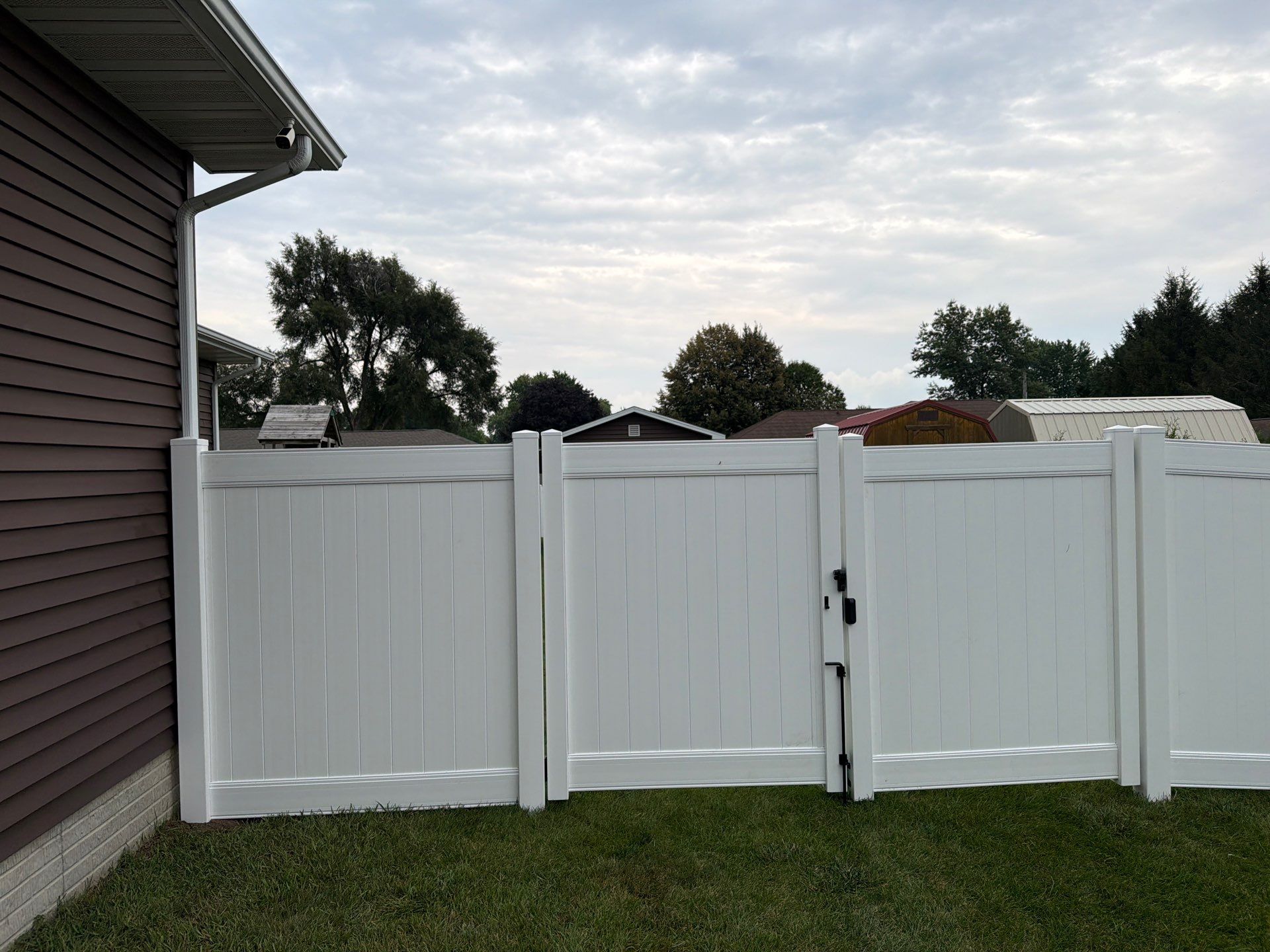 White Vinyl Privacy Fence and Double Gate Installation in Jesup by Perfect Picket Fence and Stain