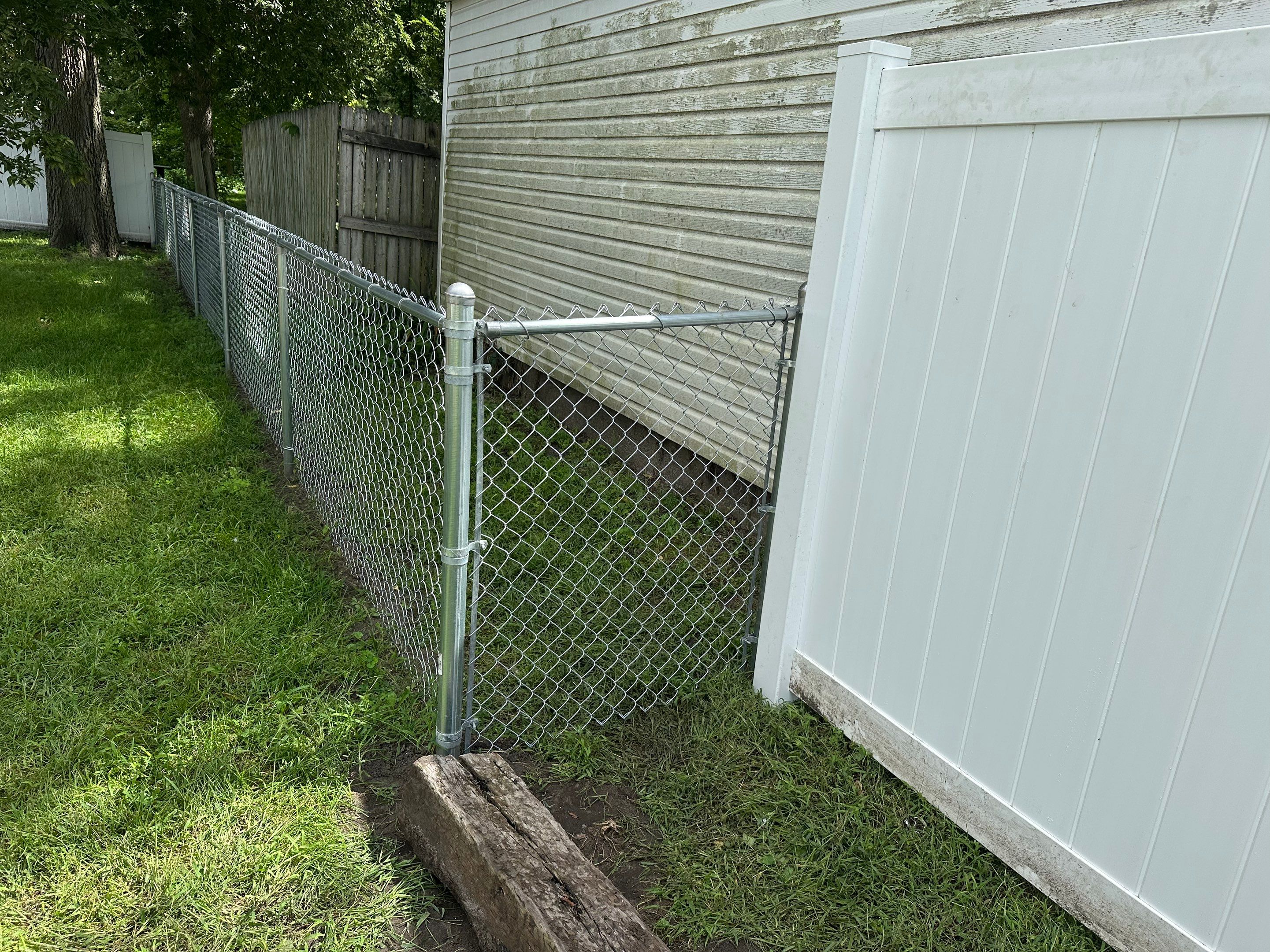 Residential White Vinyl Privacy Fence Installation in Waterloo, Iowa by Perfect Picket Fence and Stain