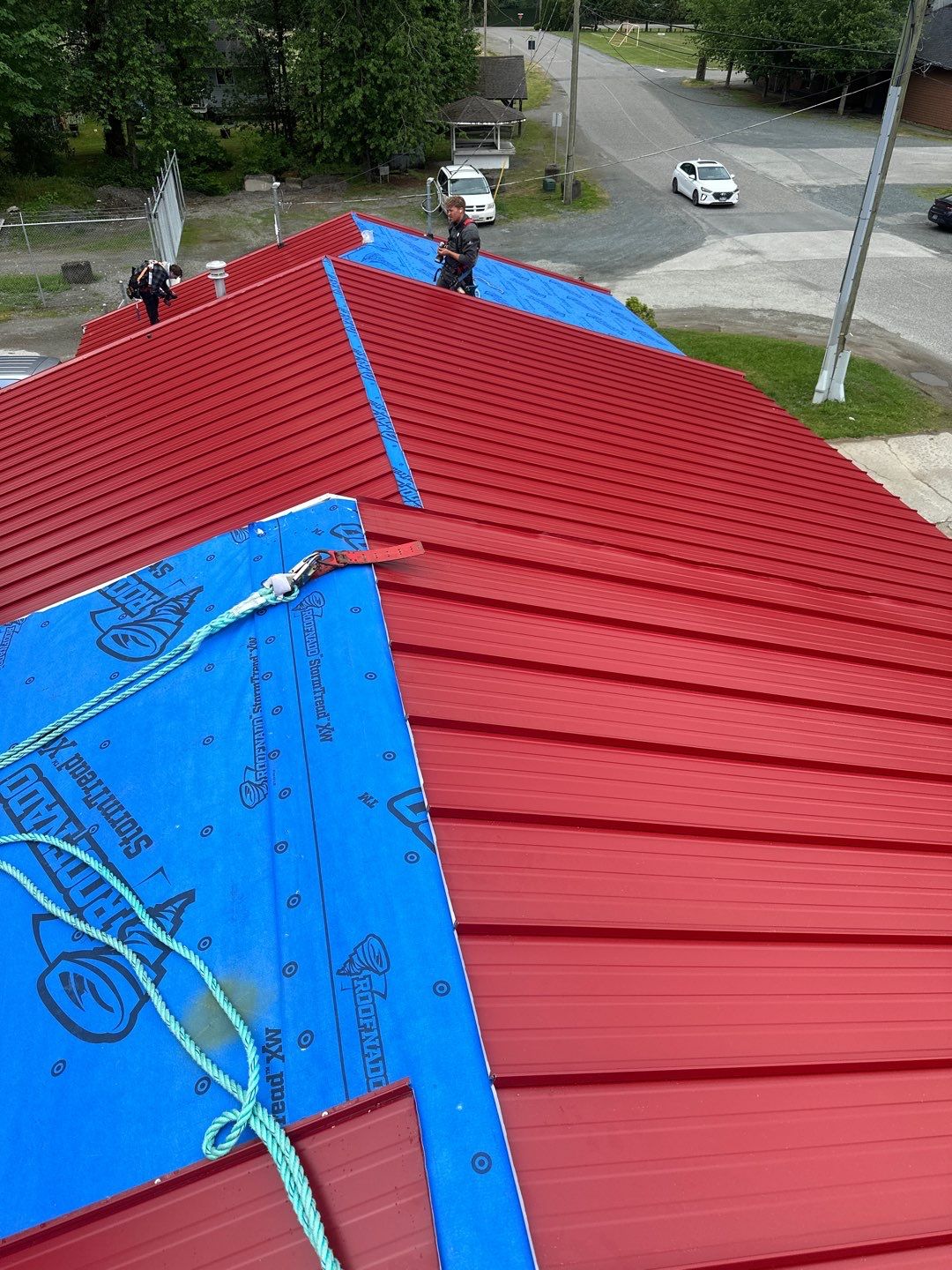 Commercial Roofing Installation using 12" Prolok metal by Top Notch Roofing Inc