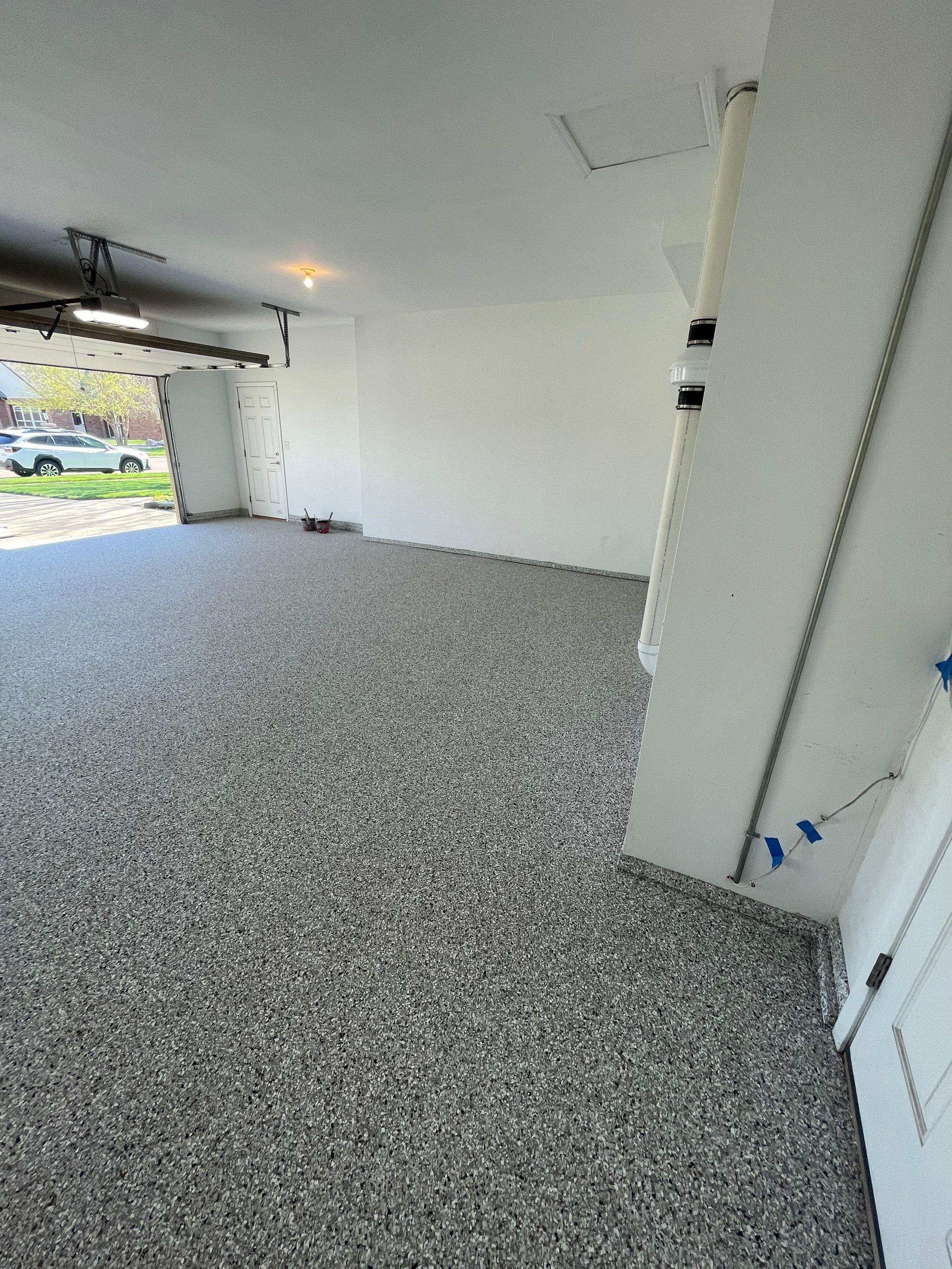 Yankton Garage Floor Restoration with Gray Speckled Epoxy Coating by Select Painting, Coatings & Garage Cabinets