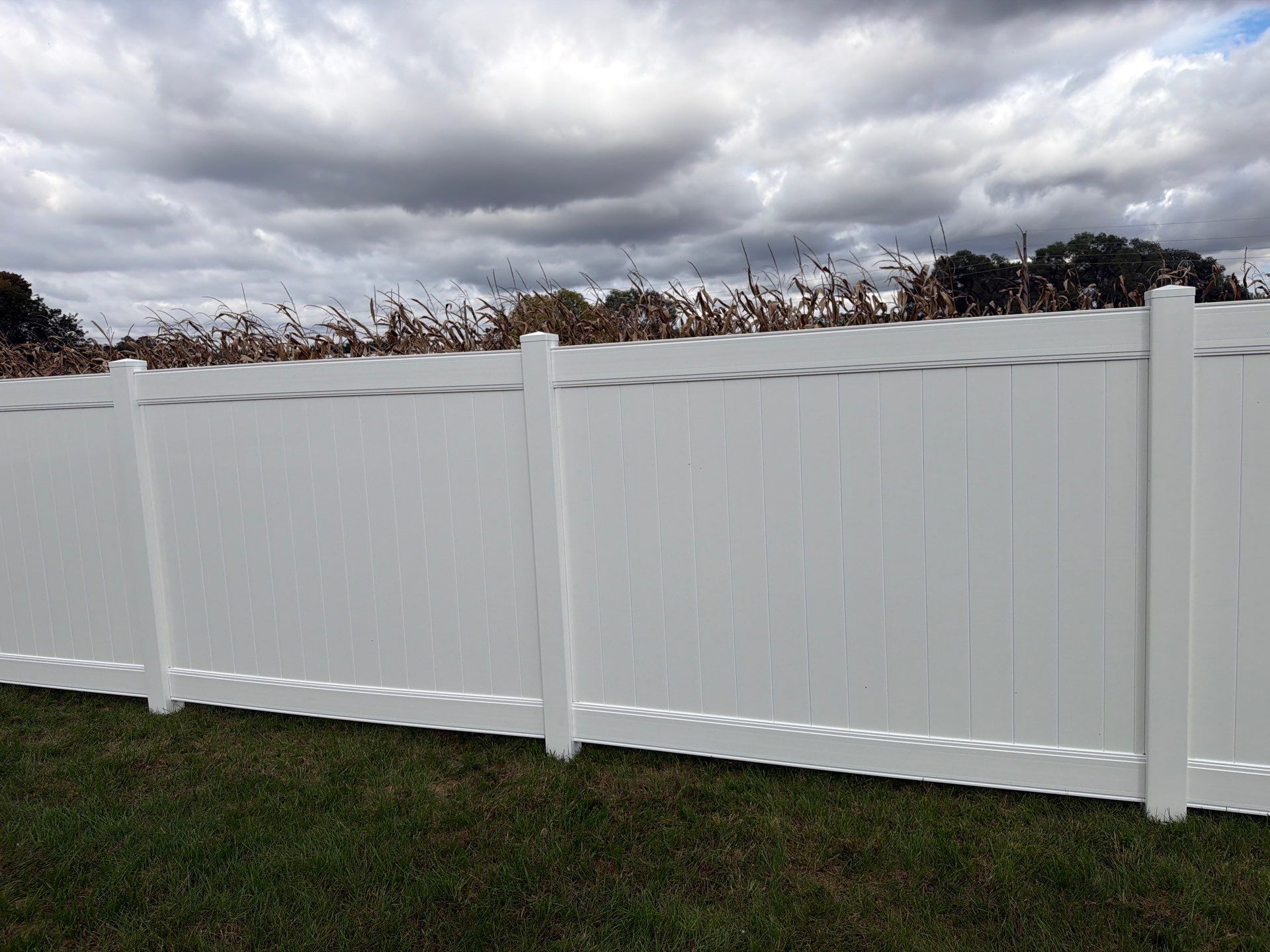 Residential White Vinyl Privacy Fence Installation in Janesville by Perfect Picket Fence and Stain