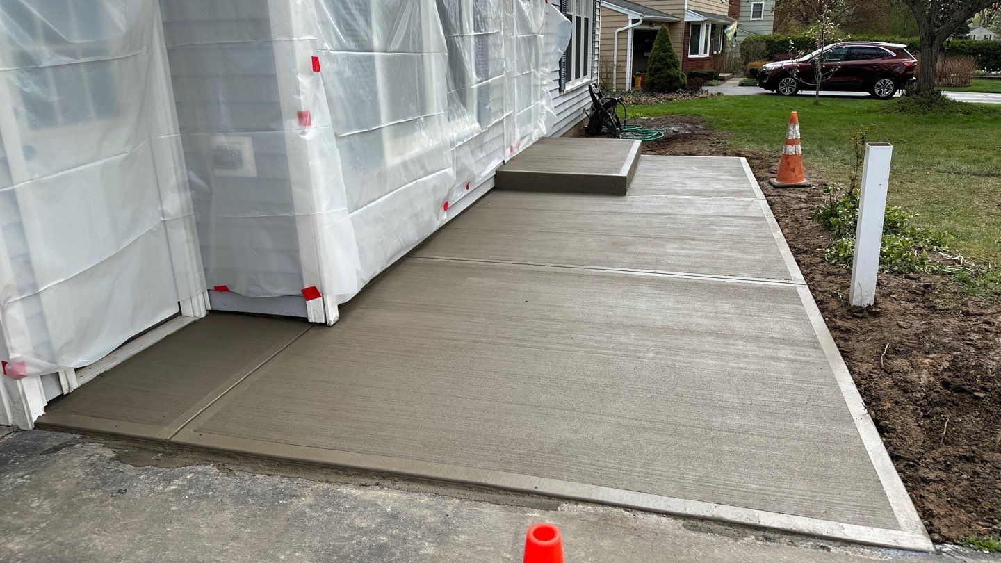 Broom finished front patio  by NG Masonry & Construction LLC